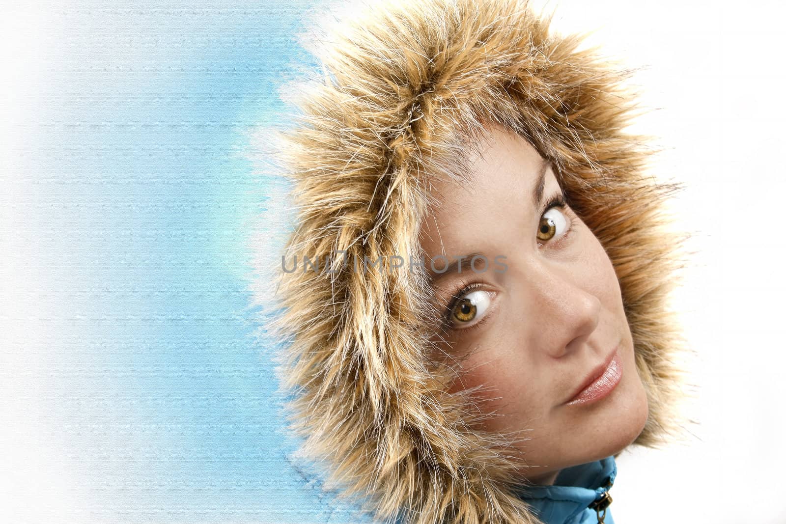 Middle aged young woman in a blue furry hood looking pleasent.