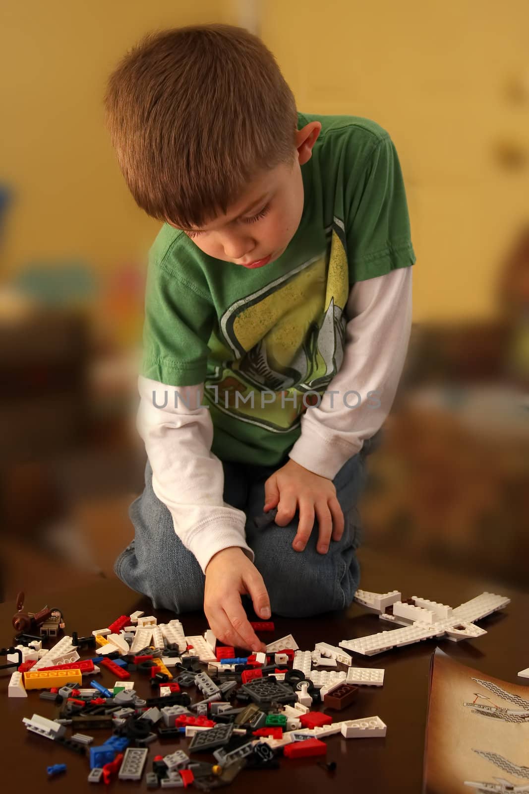 Young Boy Building an airplane with blocks.
