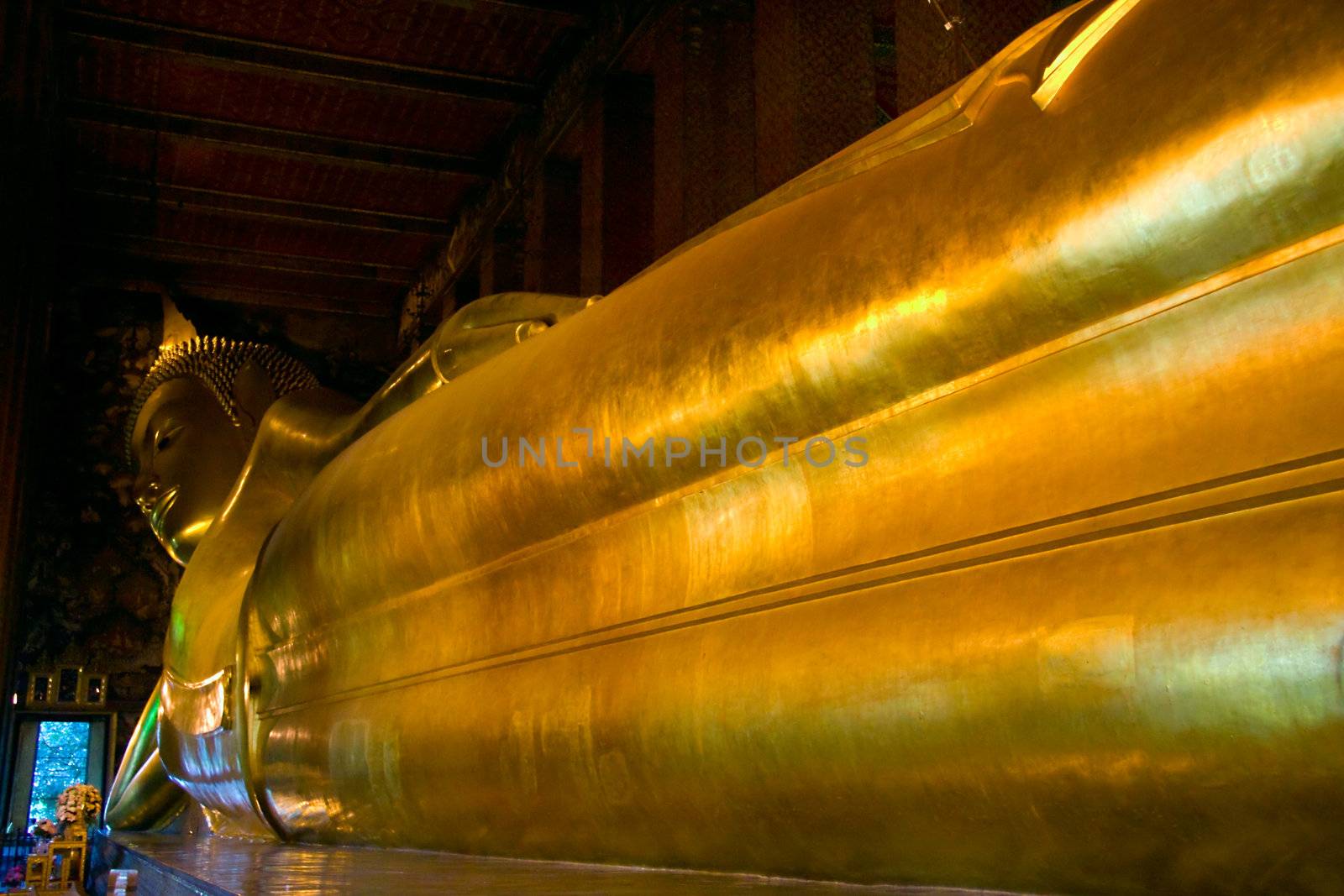The gigantic reclining Buddha of Wat Pho in Bangkok,  within the Wat Pho (also named wat po, wat phra chetuphon or Grand Palace) in Bangkok, Thailand. 