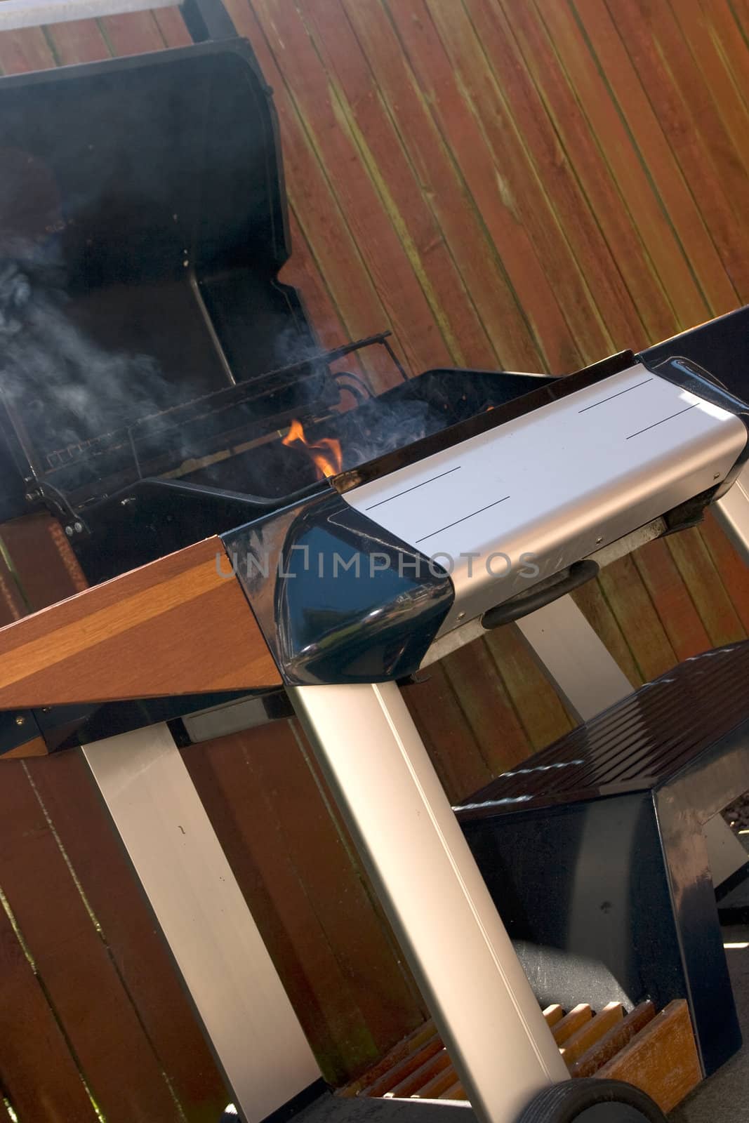 Chrome and blue Barbecue fire with orange flames and black charcoal