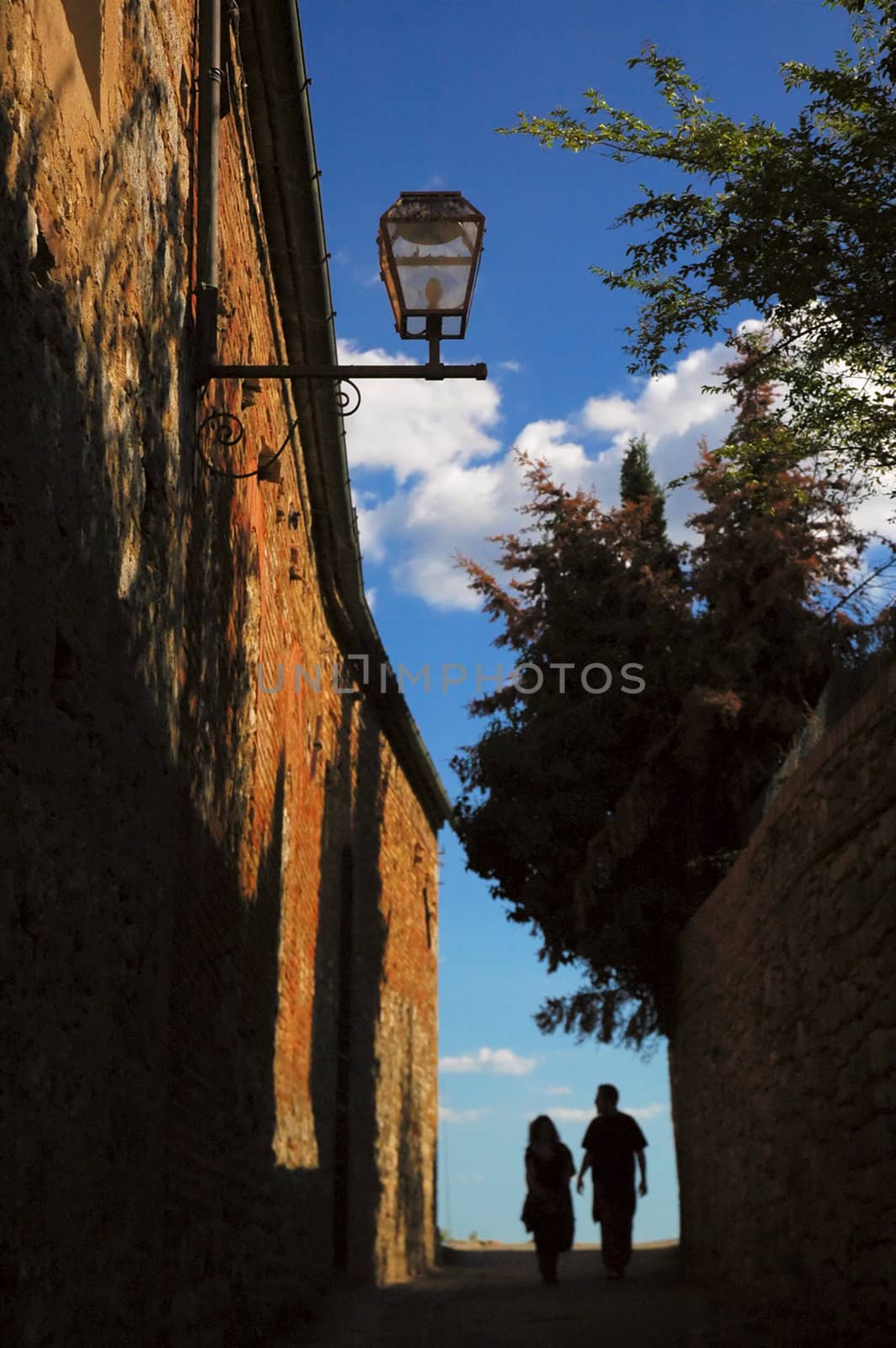 Couple walking at San Gimignano street