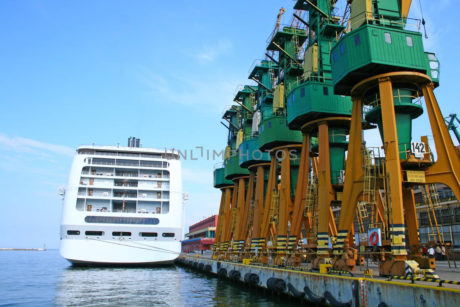 Moored passenger cruise liner and cranes at harbor