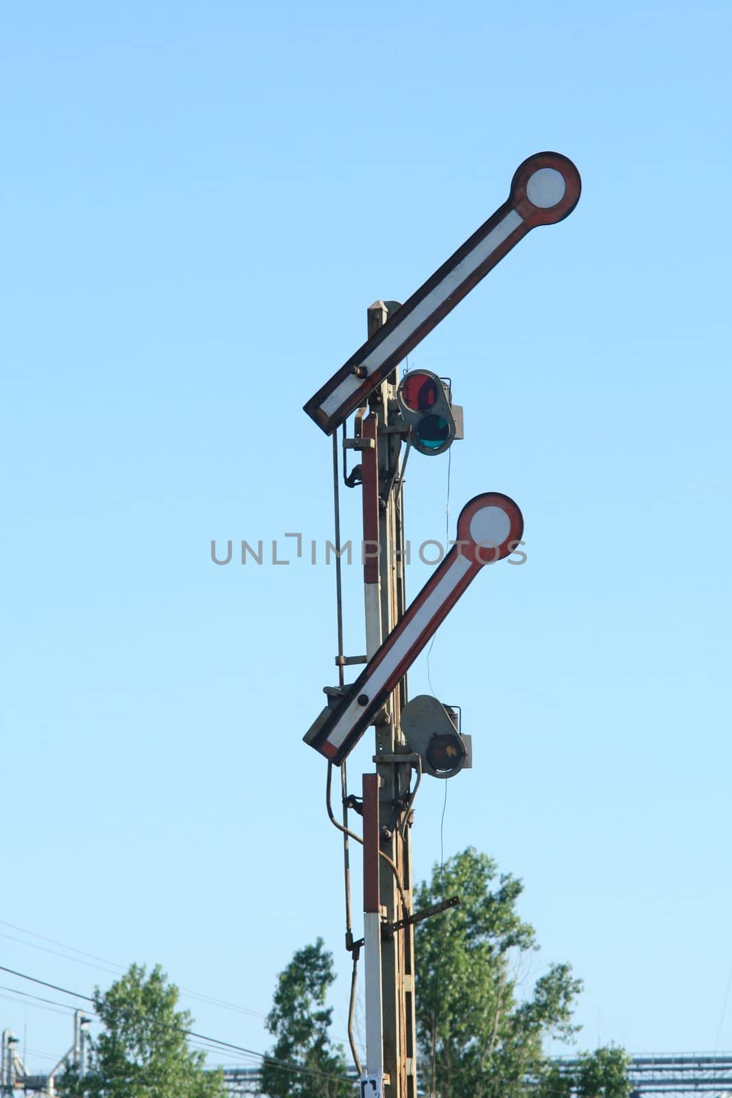 Old railway mechanical semaphore on the blue background