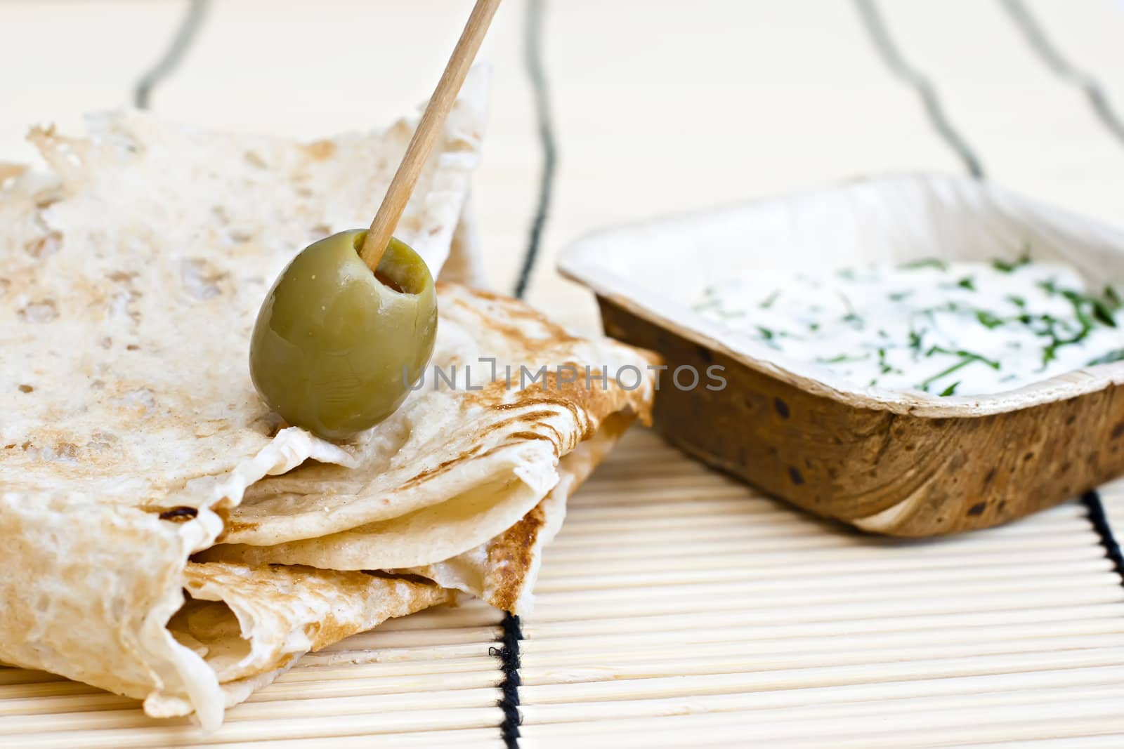wheat bread with olive and dip.