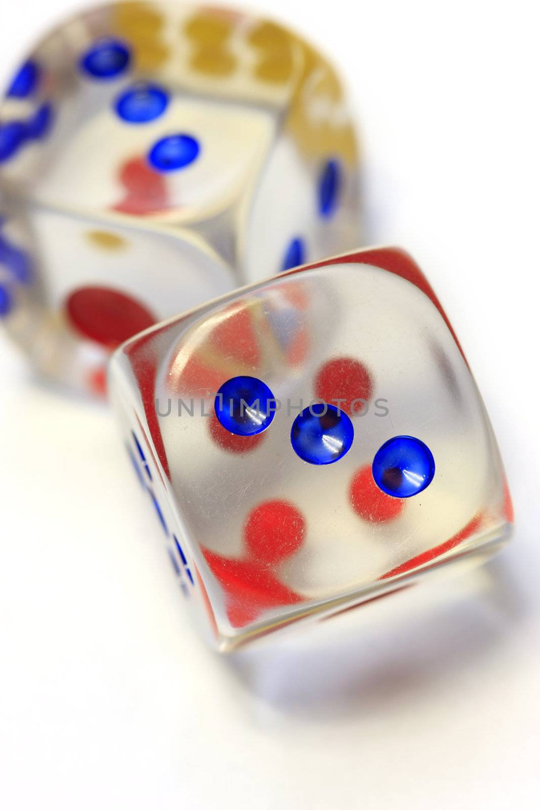 off balance, vertical shot of dice in white background