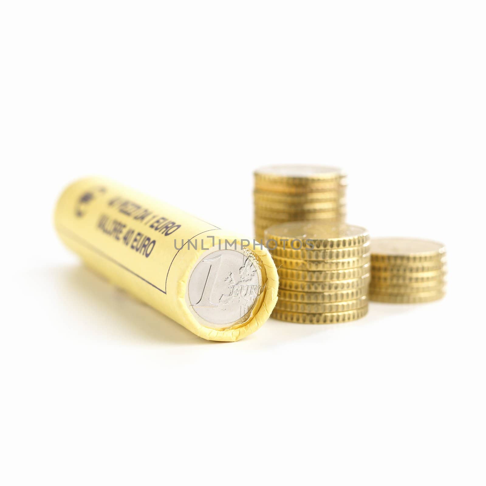 Roll of euro coins and stacks of 50 cents on white