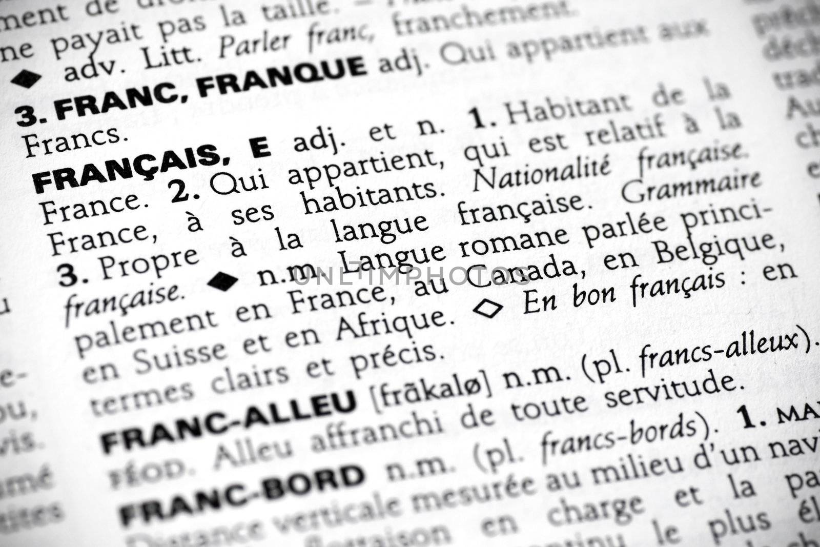 Macro shot with focus on the word fran�ais and its definition in a french dictionary.