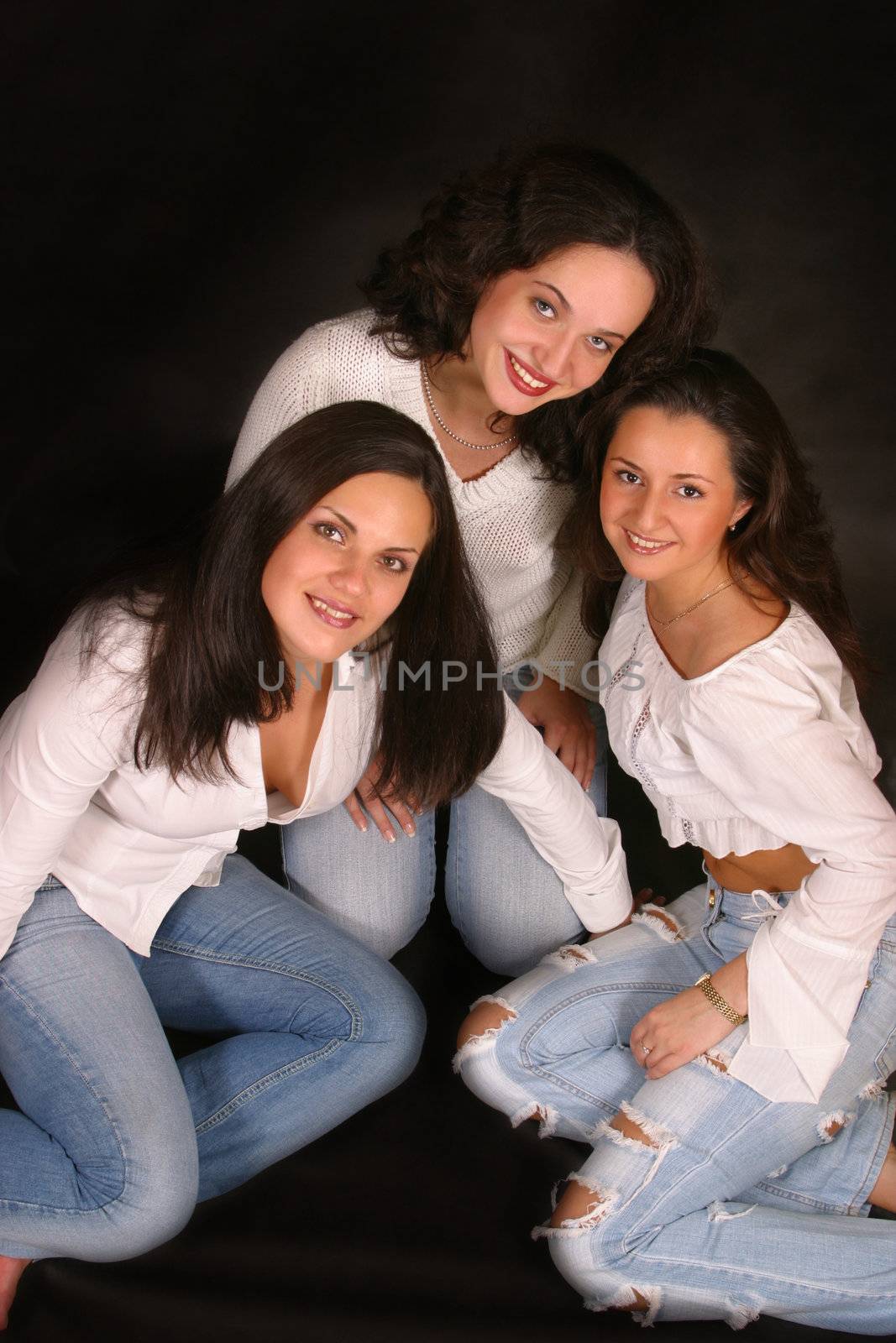 Three young girls lay in studio