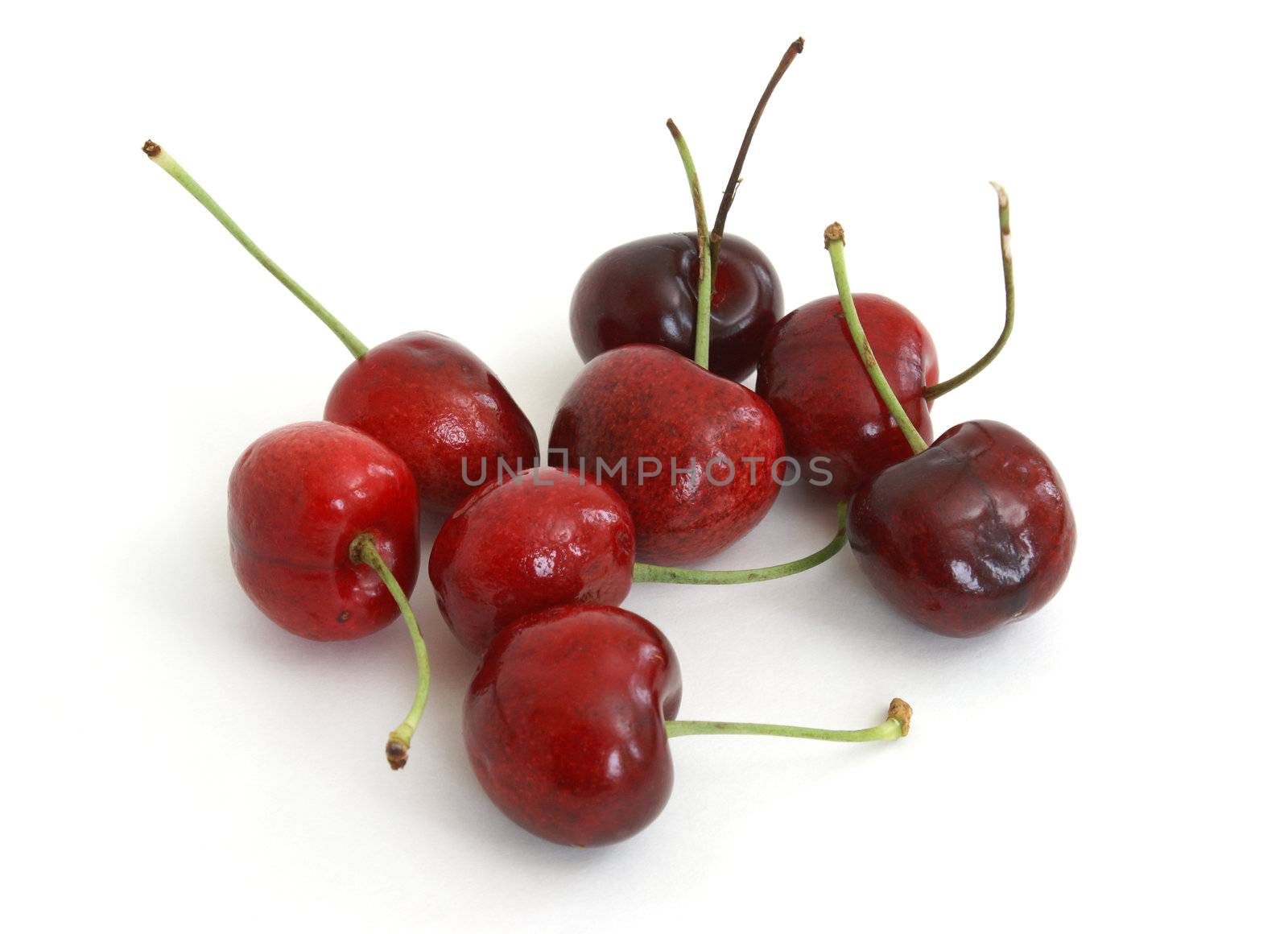 A cluster of ripe cherries on white background.