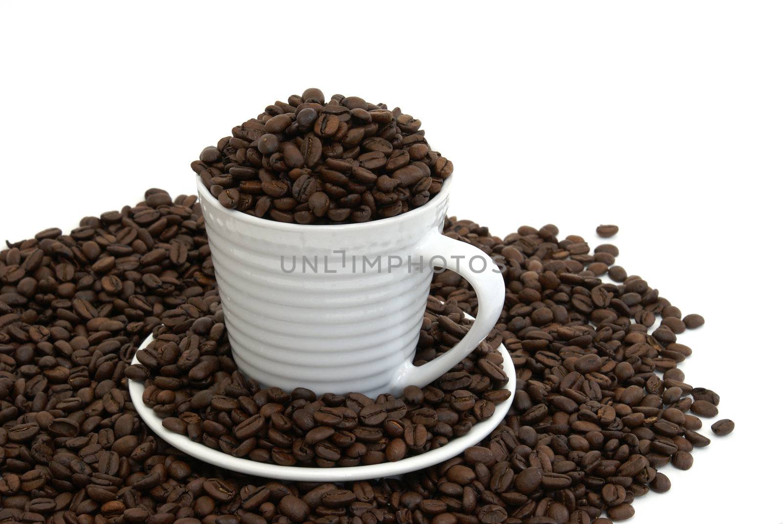 A cup and saucer full of fresh coffee beans.