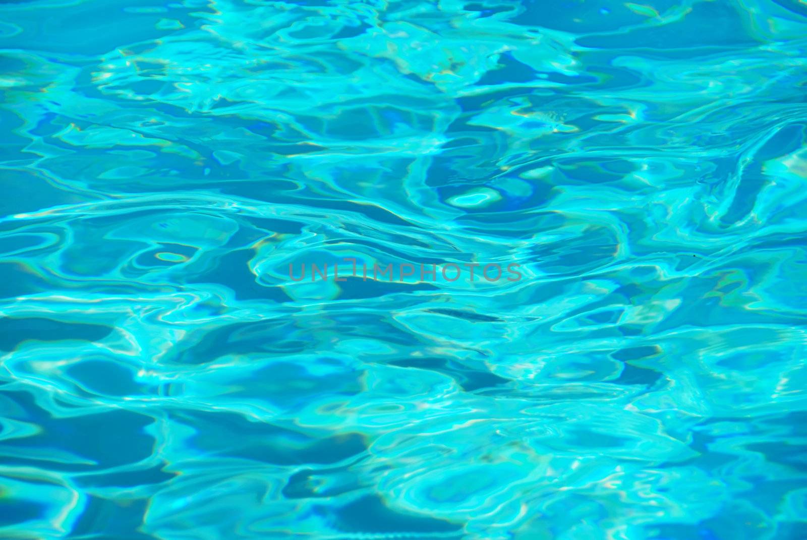 Crystal clear blue water in swimming pool.