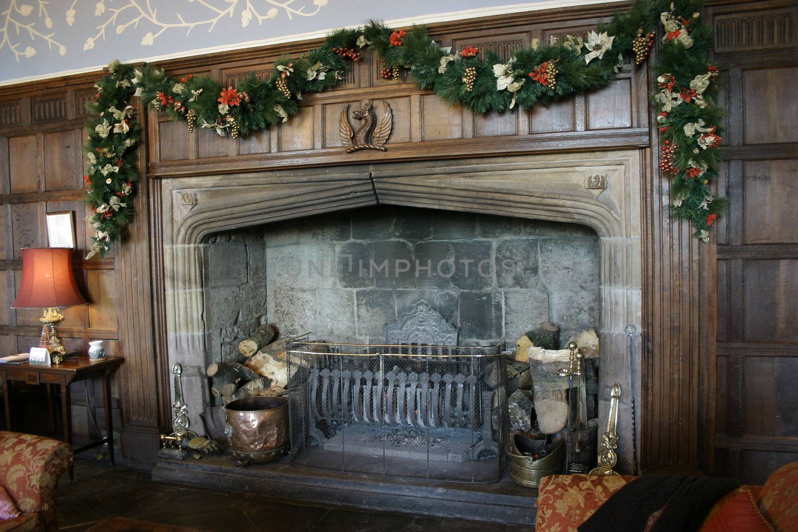 large majestic fireplace decorated for the christmas season