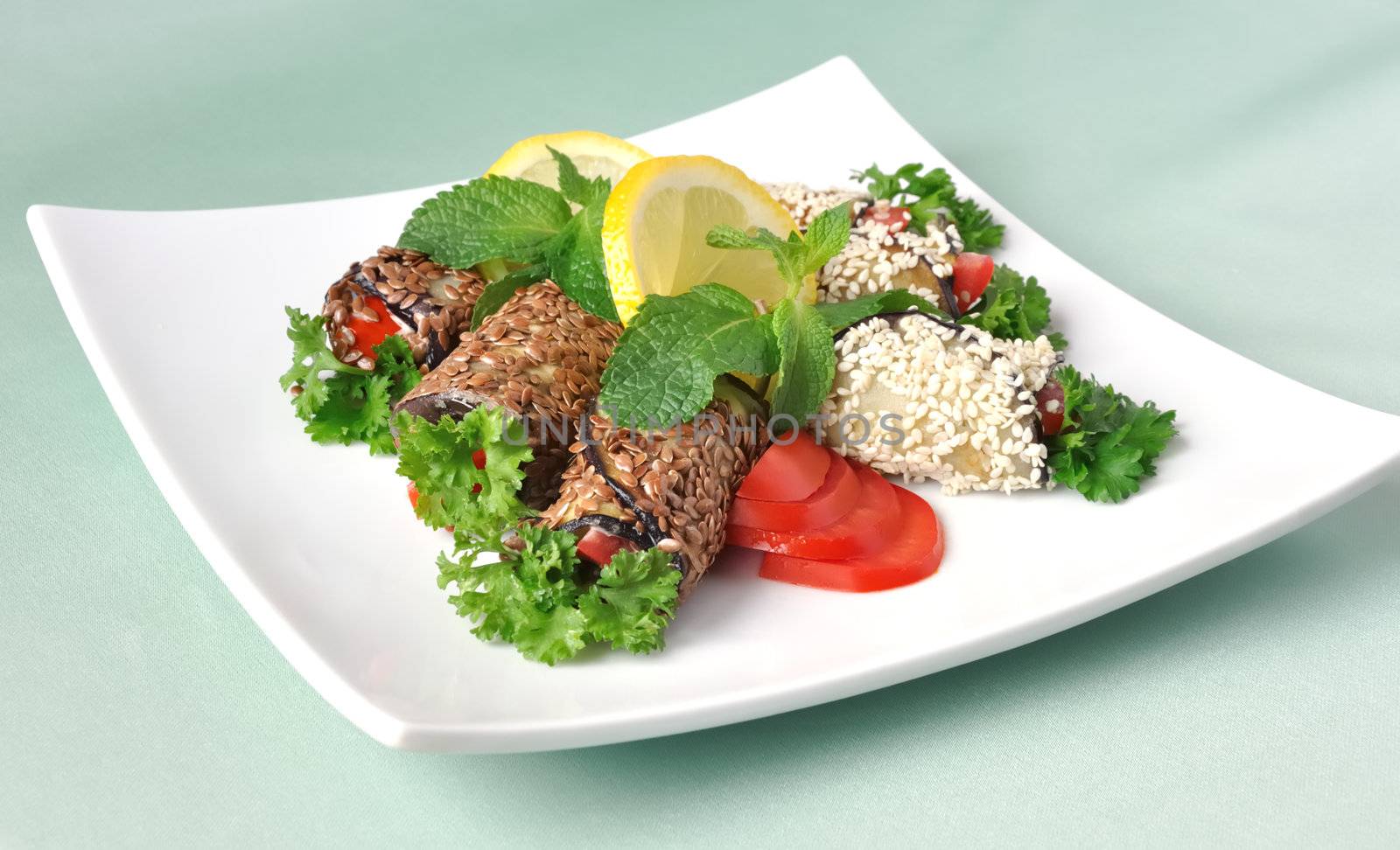 Rolled eggplant with tomatoes in sesame and flax seed