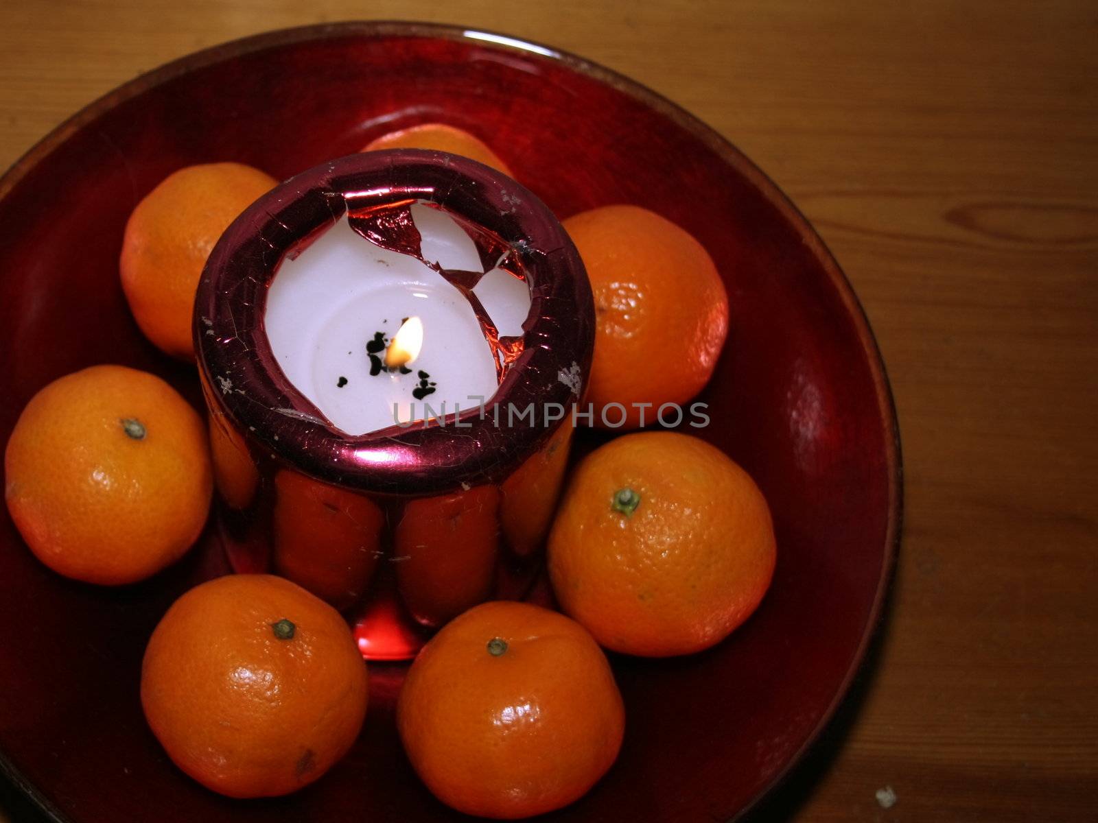festive candle and clementines by leafy