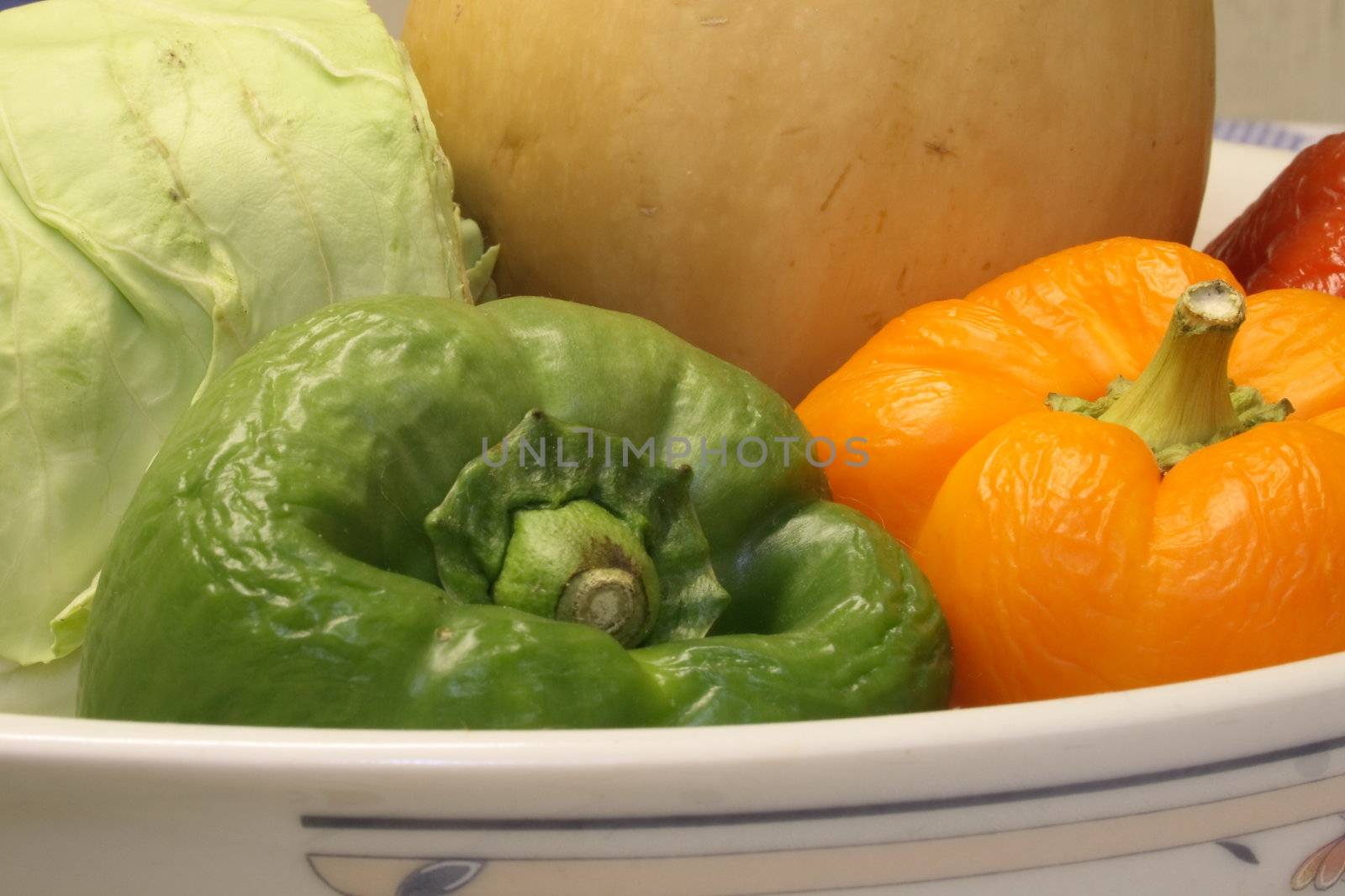 old peppers and cabbage with butternut squash in a dish showing how they dry up with age