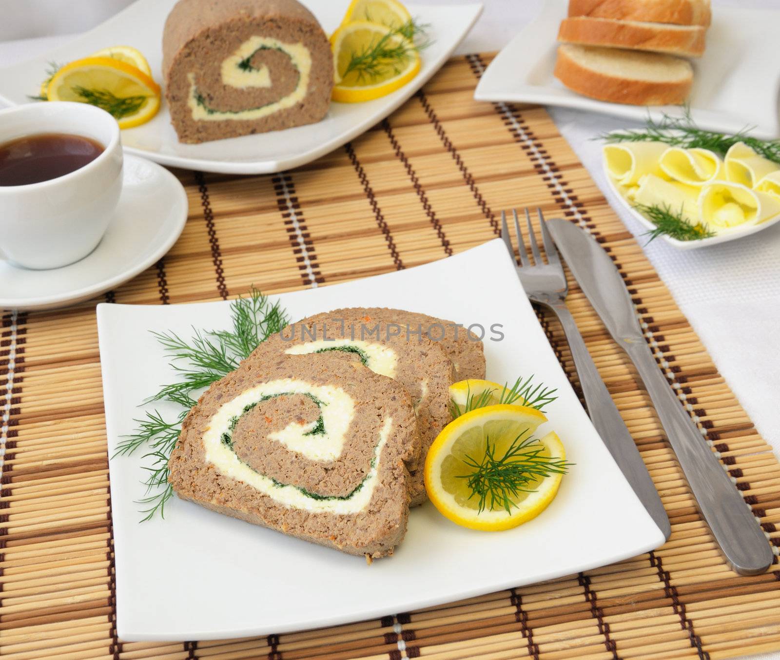 Slices of liver pate with butter and coffee for breakfast