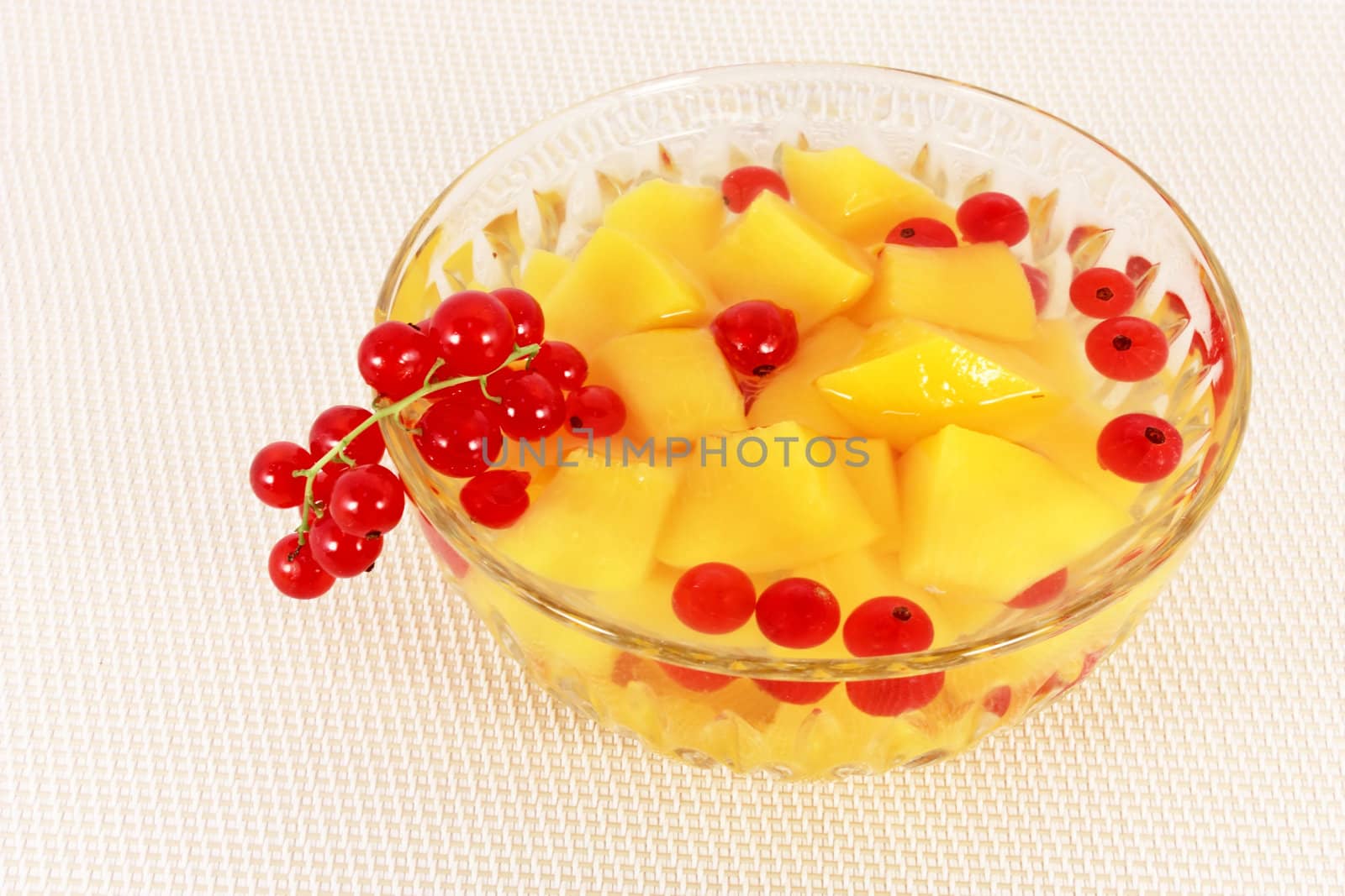 Peach and currant compote in glass bowl