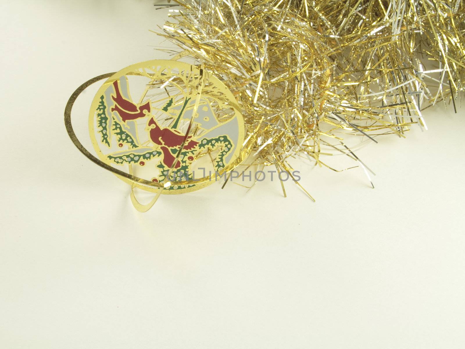 gold  tinsel with delicate  christmas decorations for hanging on the christmas tree isolated over white background
