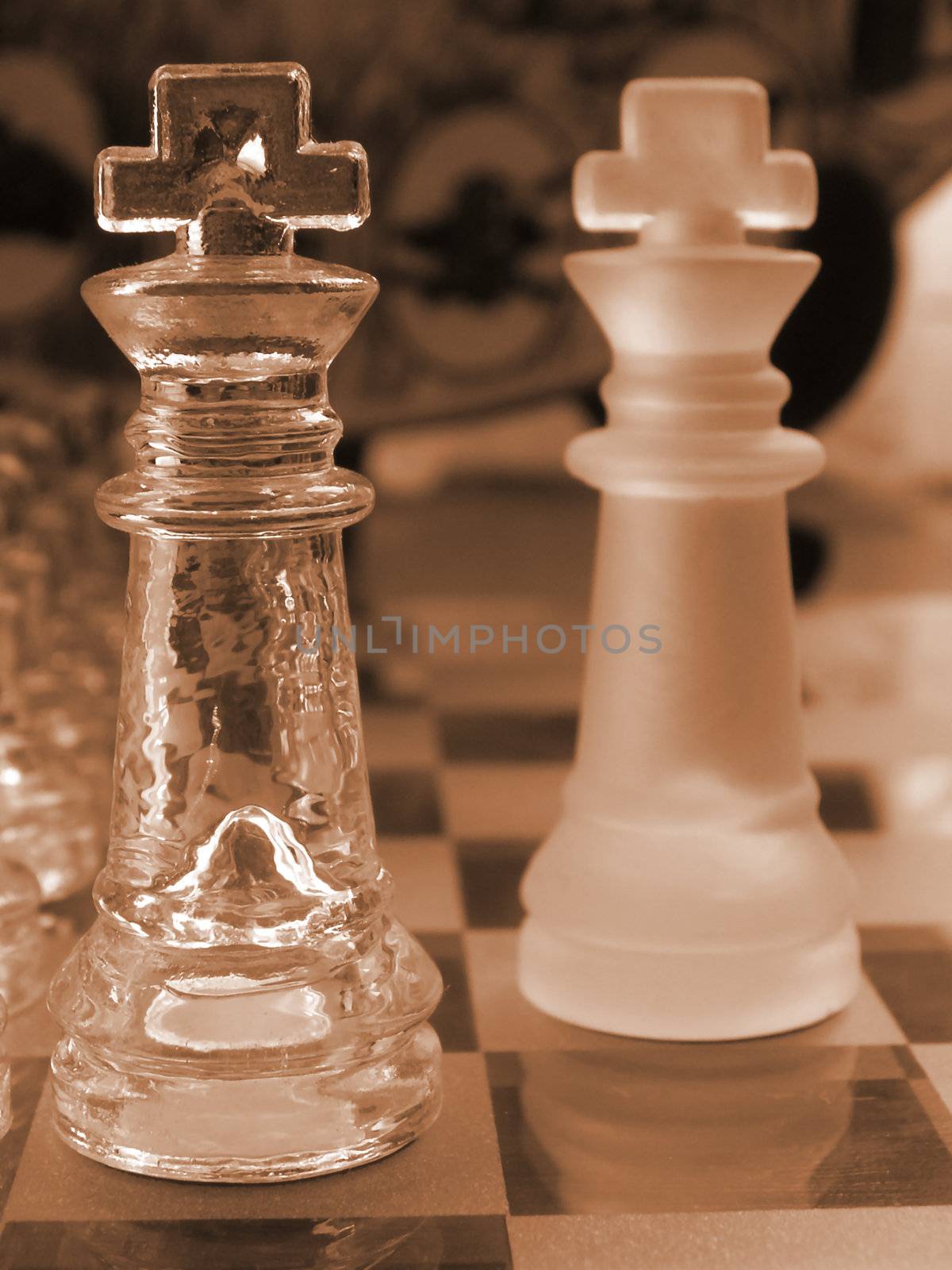 glass chess set game with a engraved glass playing board coloured sepia the clear king  is the focal point