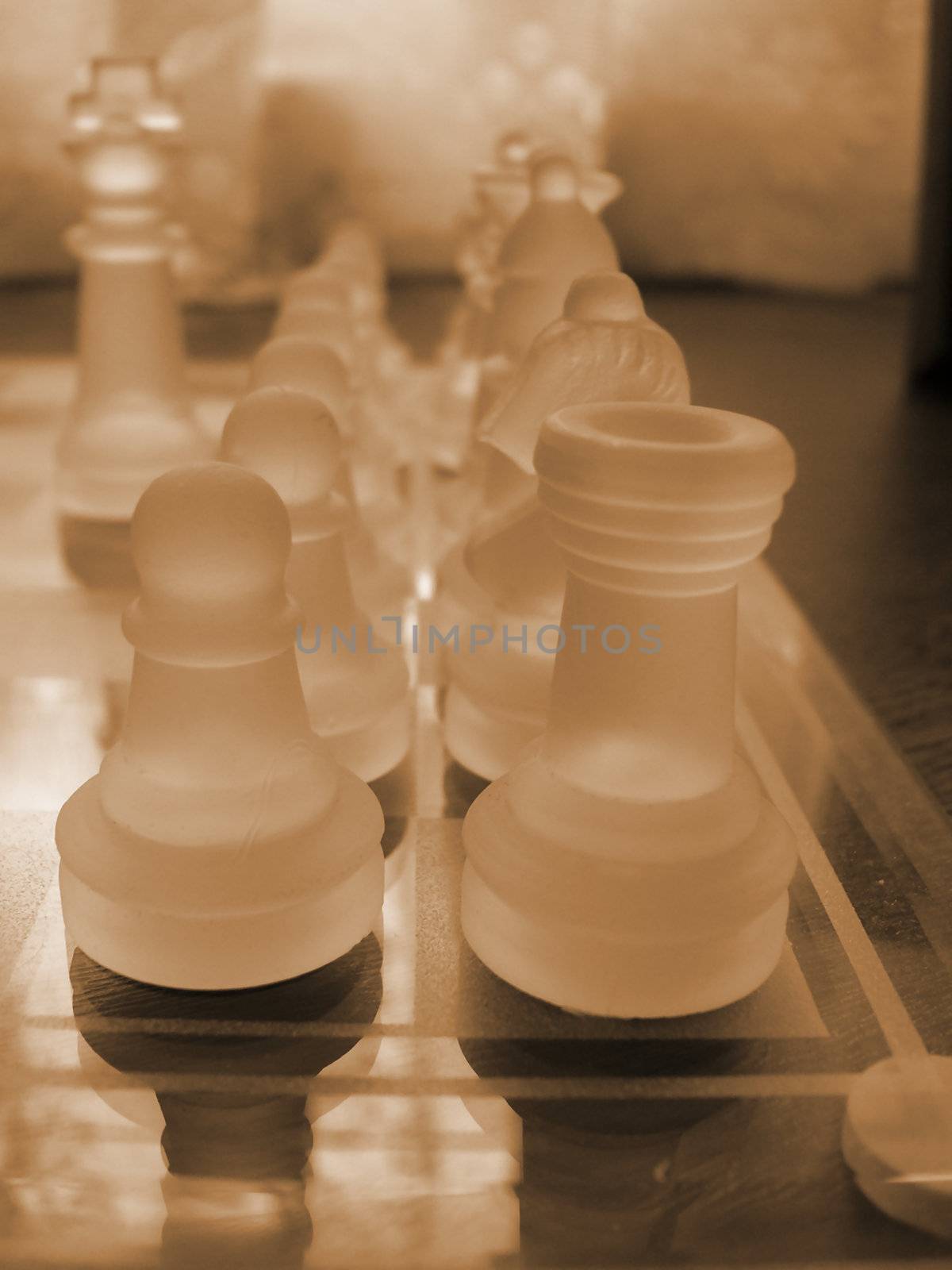 glass chess set game with a engraved glass playing board coloured sepia the castle front pawn  is the focal poin