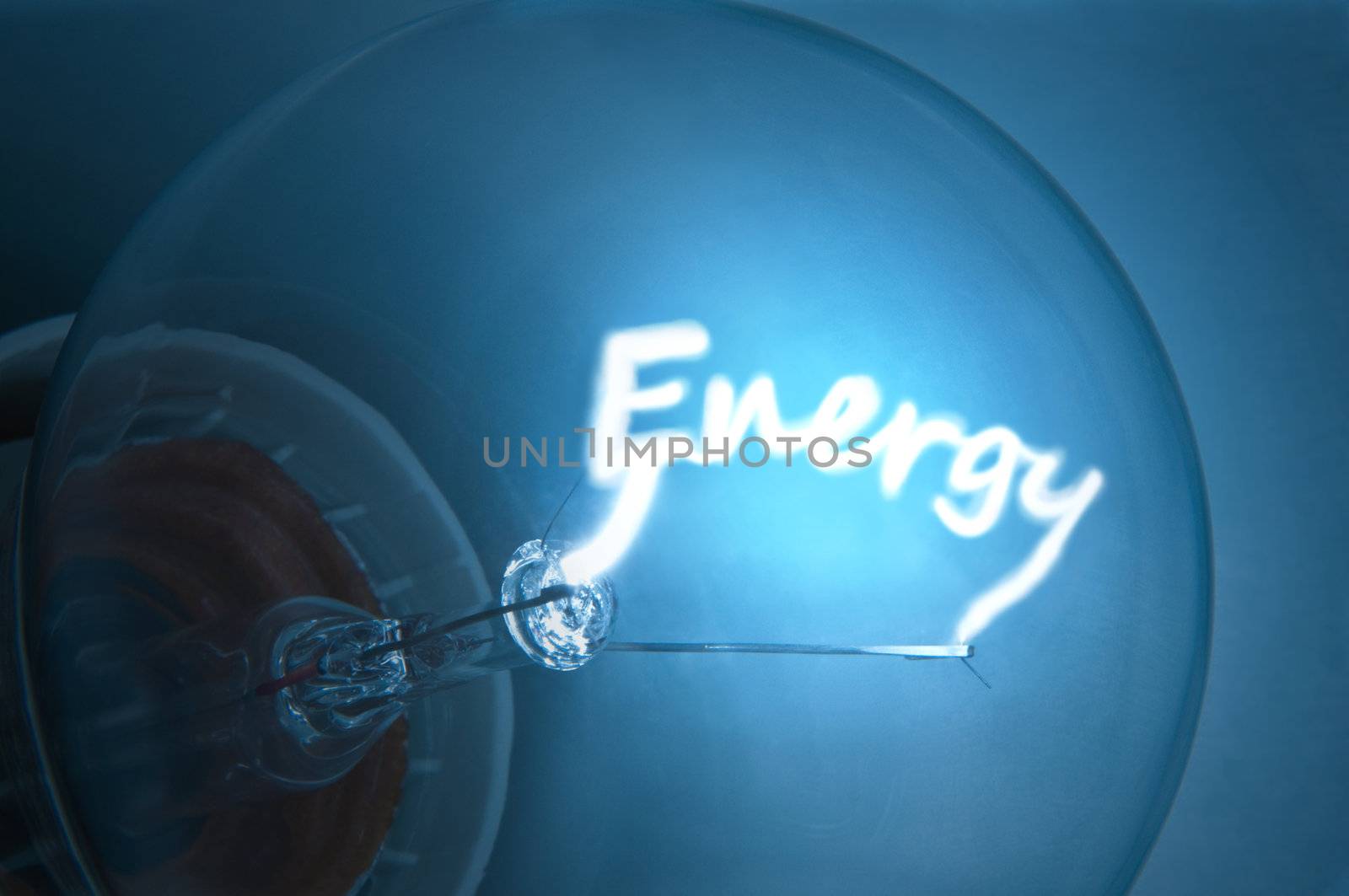 Close up on illuminated blue light bulb filament which spells the word "Energy".