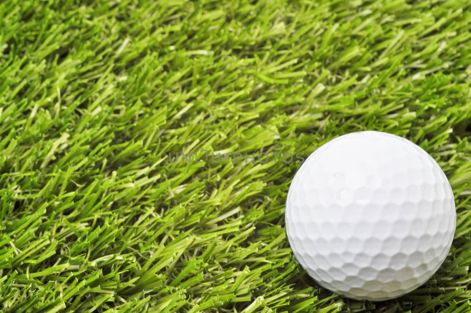 Closeup of golf ball  on grass with copy space.