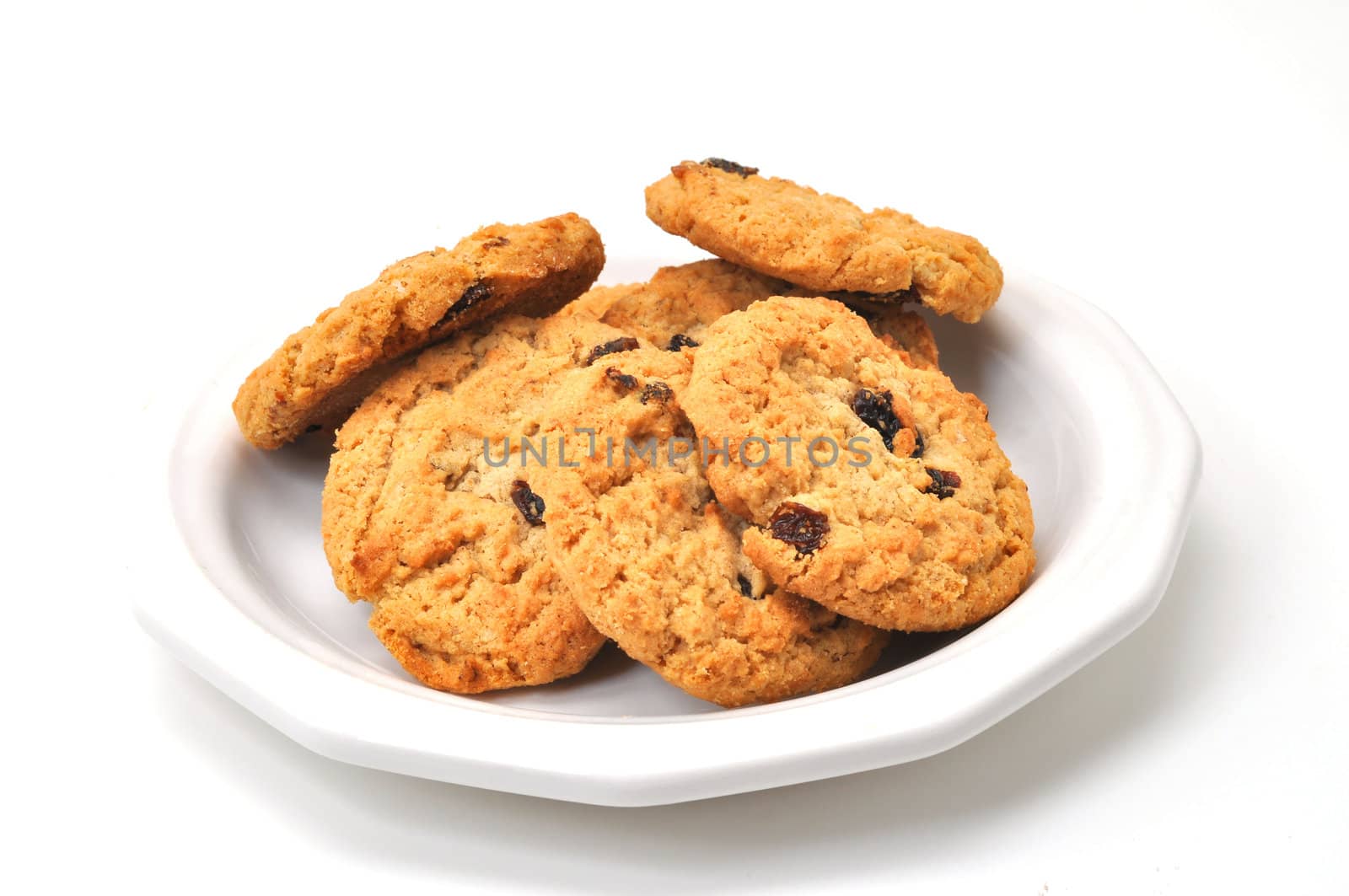 Oatmeal cookies on plate isolated on white background.