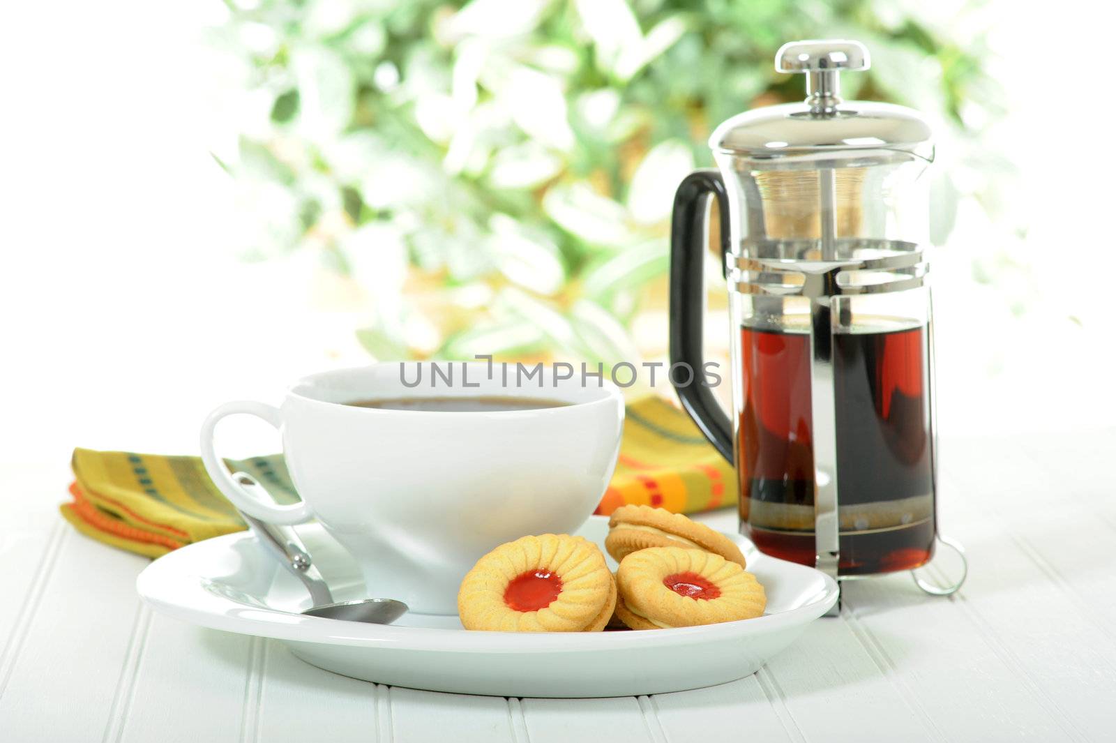 Delicious cream filled vanilla cookies with a cup of coffee.