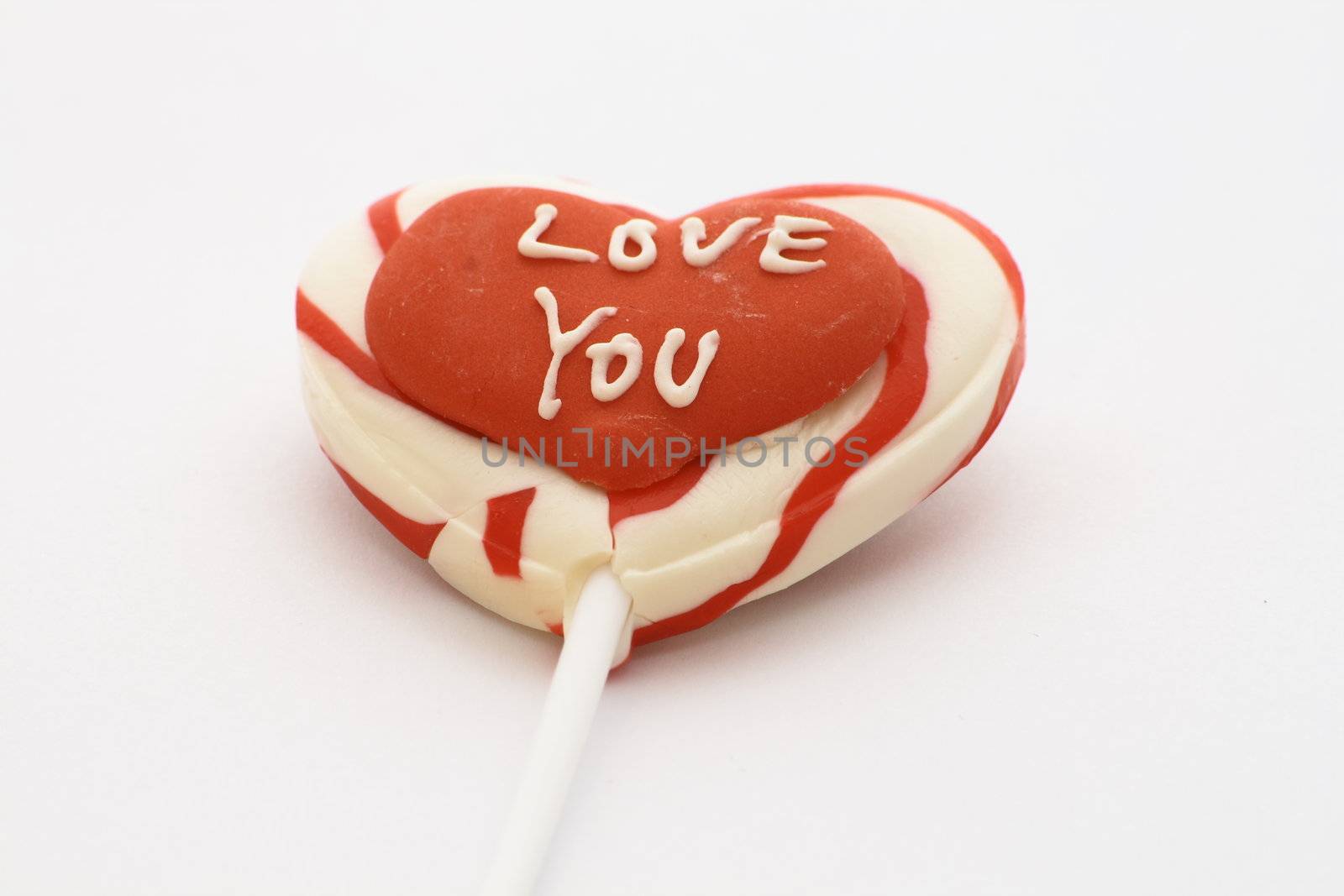 candy lolly with love you written on a red heart