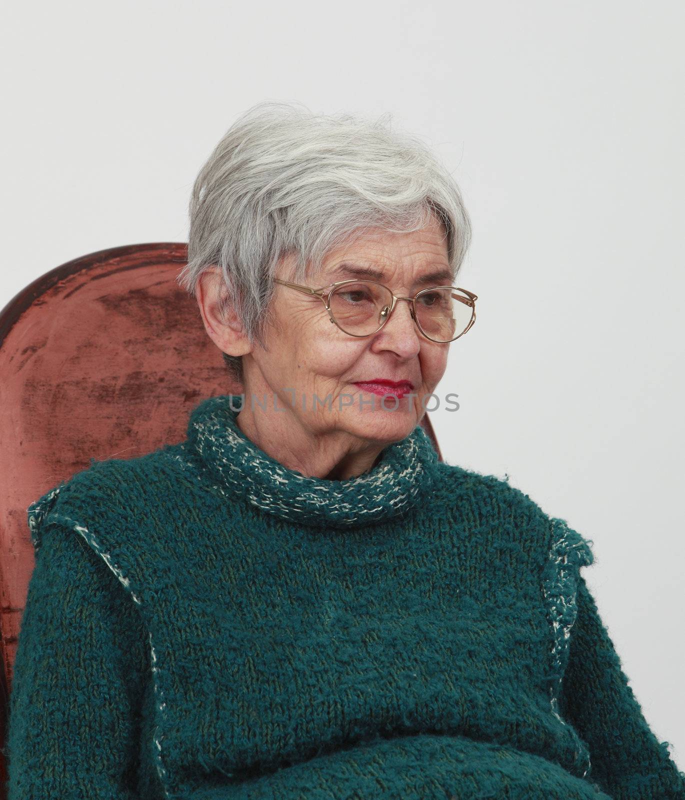 Portrait of an old woman against a grey background