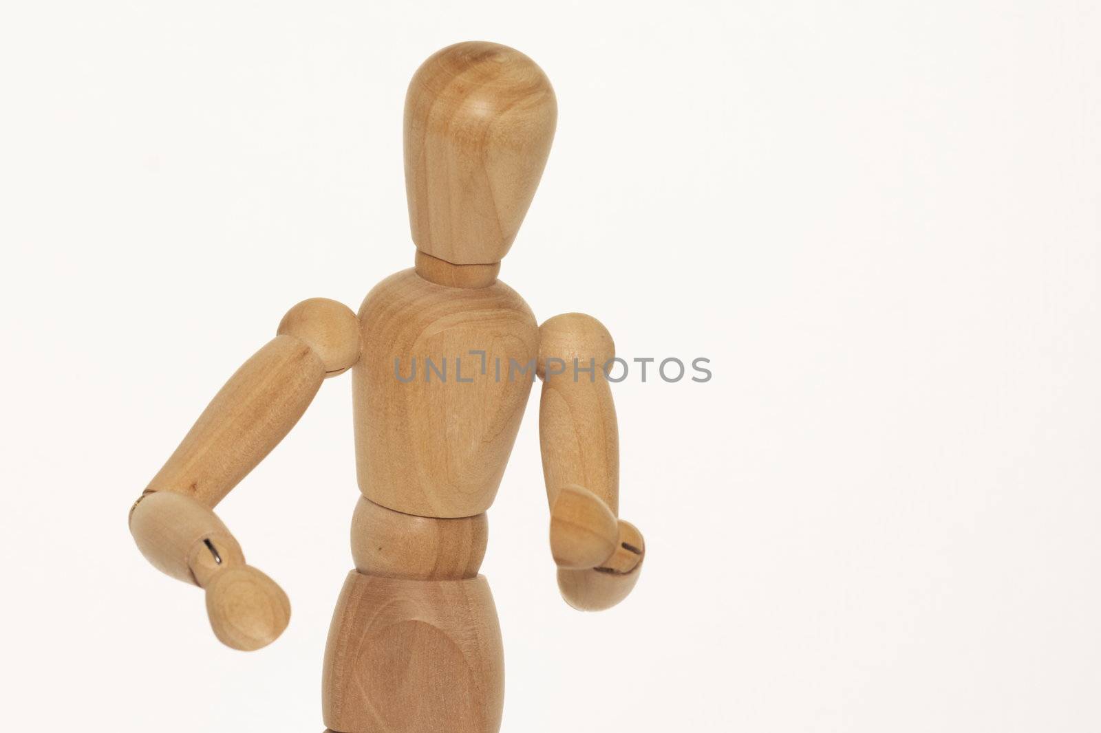 wooden mannequin against a light background