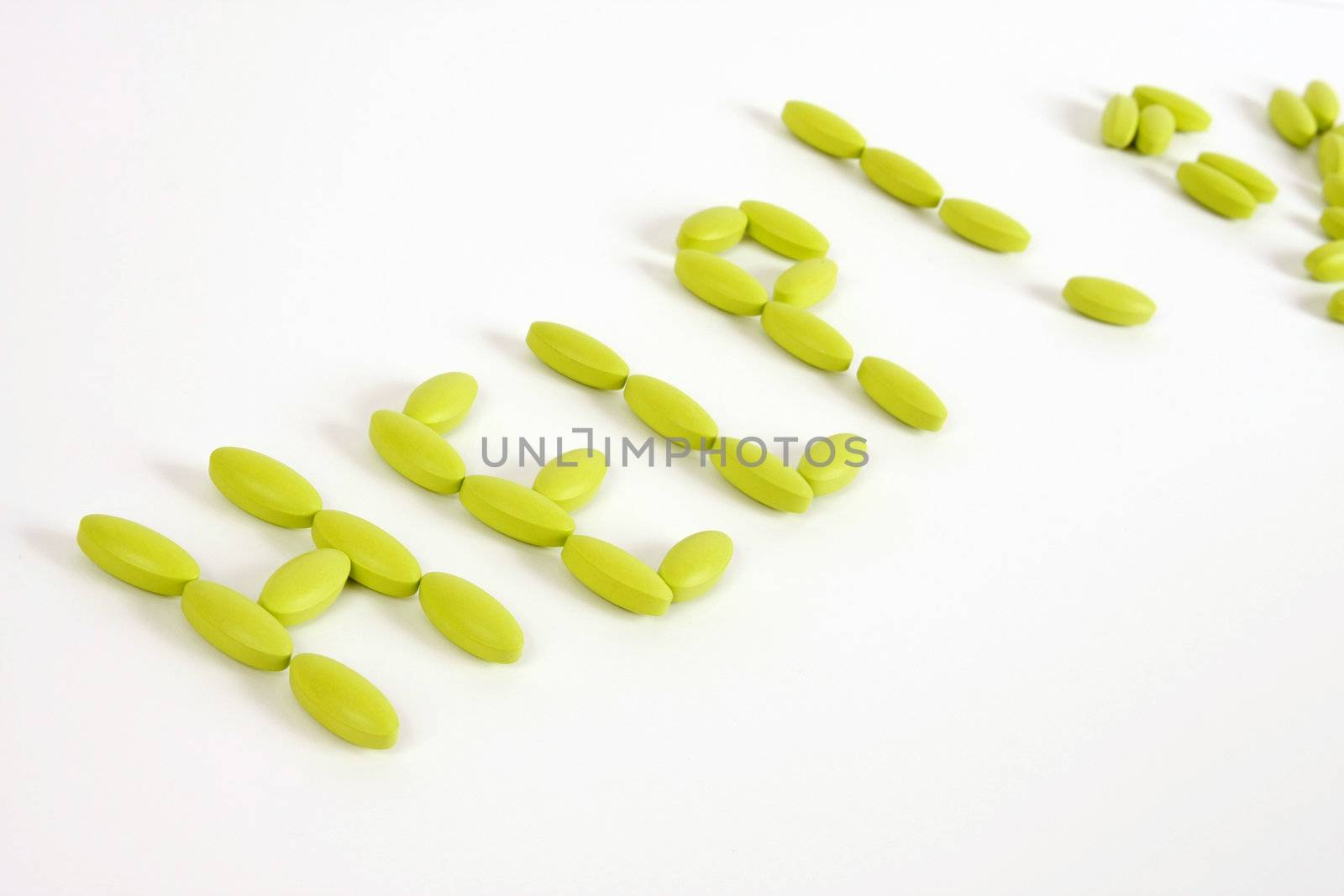 Green pills on a white background spell out help.