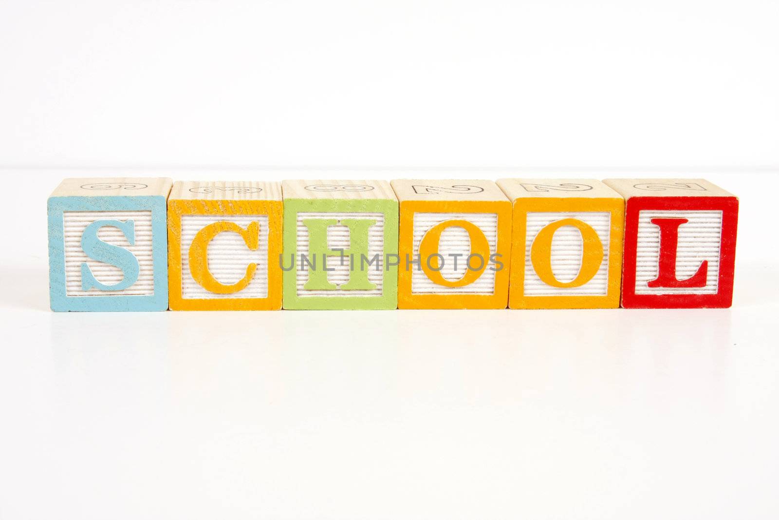 Colorful childrens blocks spell the word school.