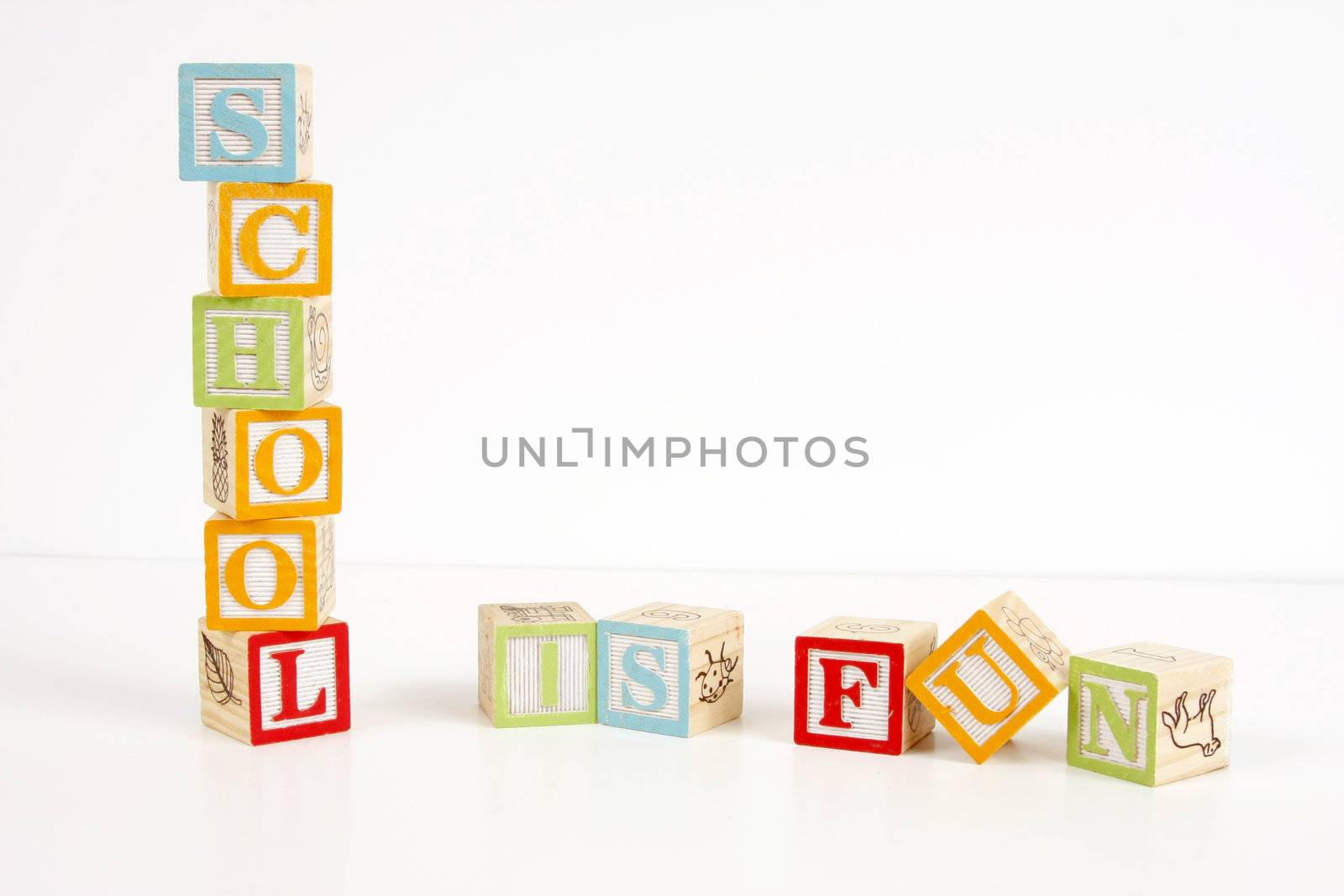 Colorful childrens blocks spell the words school is fun.