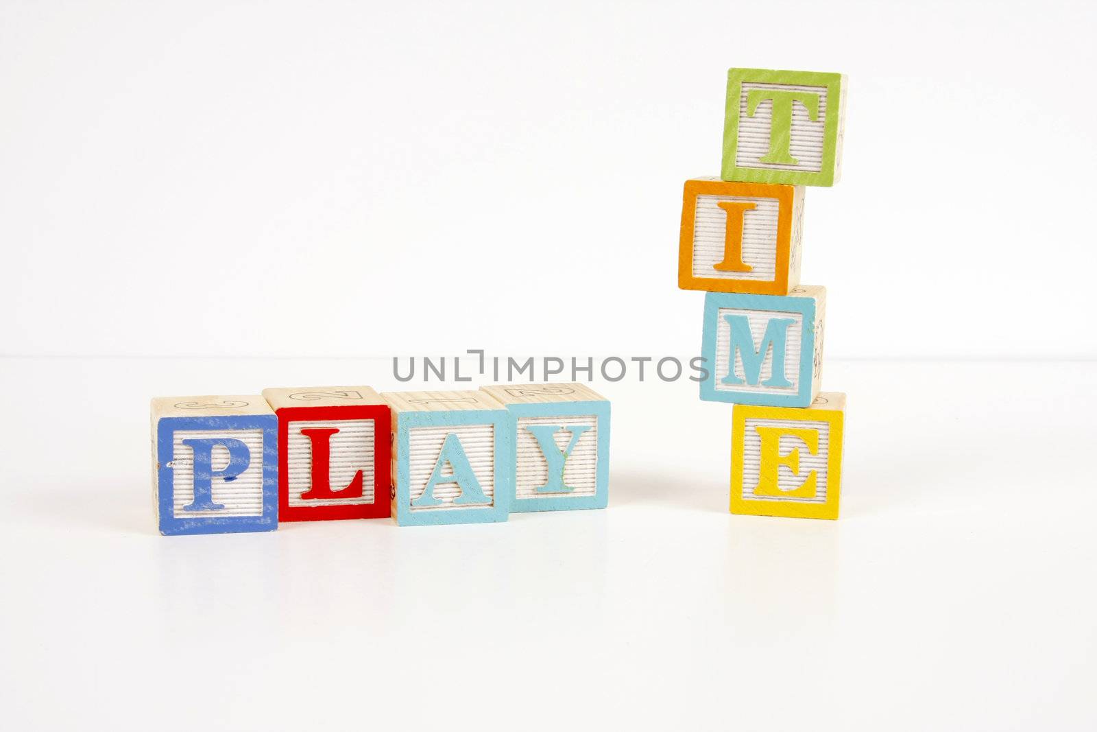 Colorful childrens blocks spell the words play time.