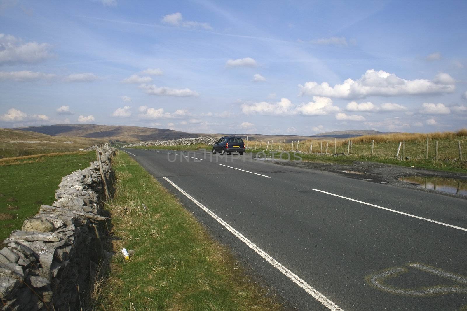 car on the road in the yorkshire dales