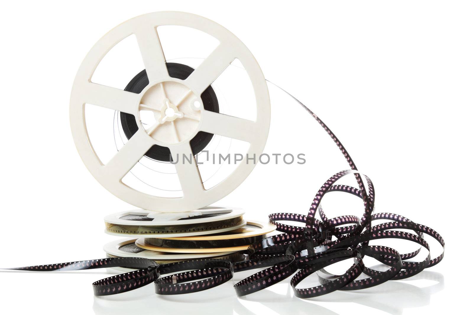 Old 8mm film and stack of canisters isolated over white background