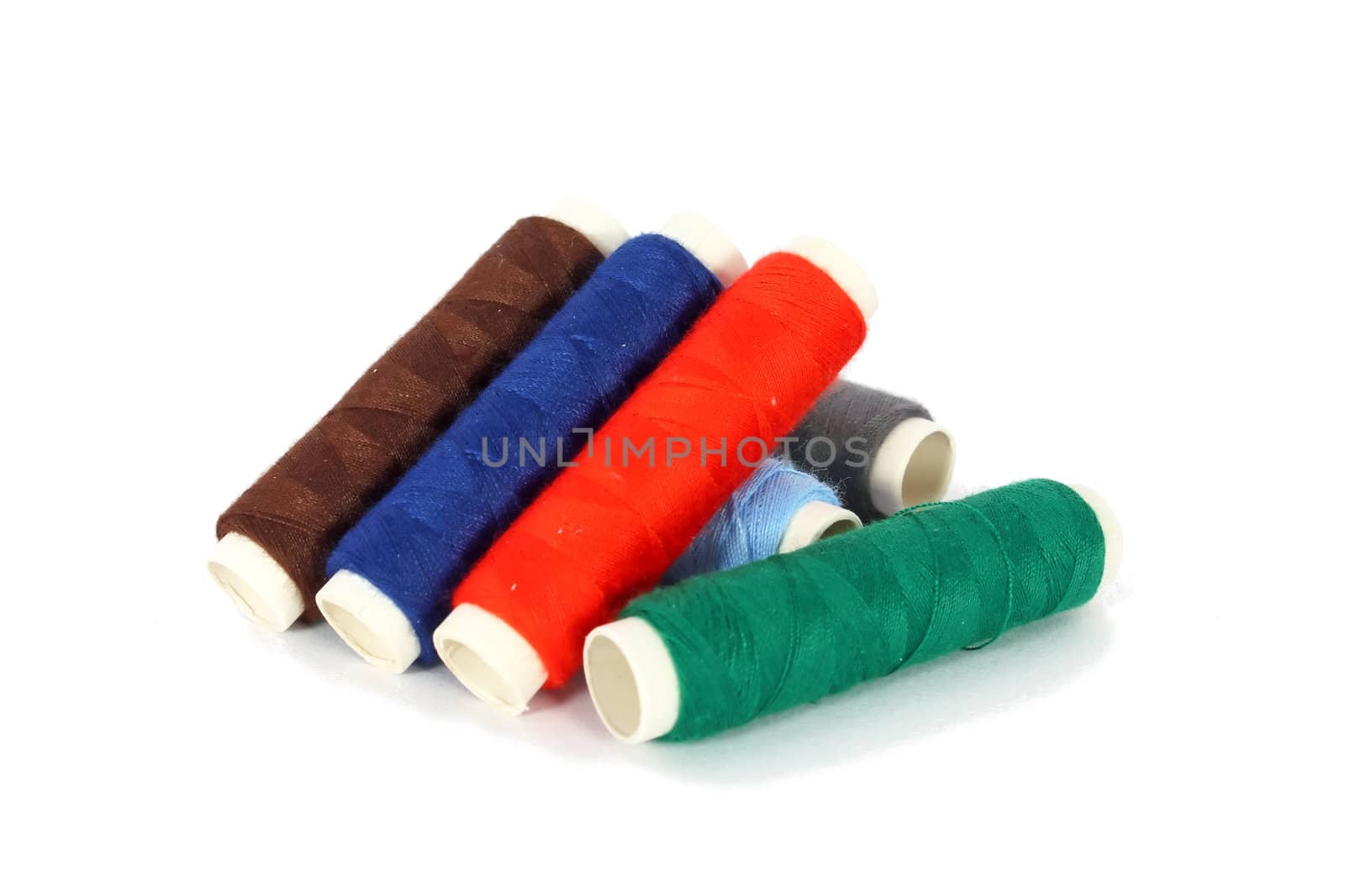 Bobbins of colored thread isolated on white