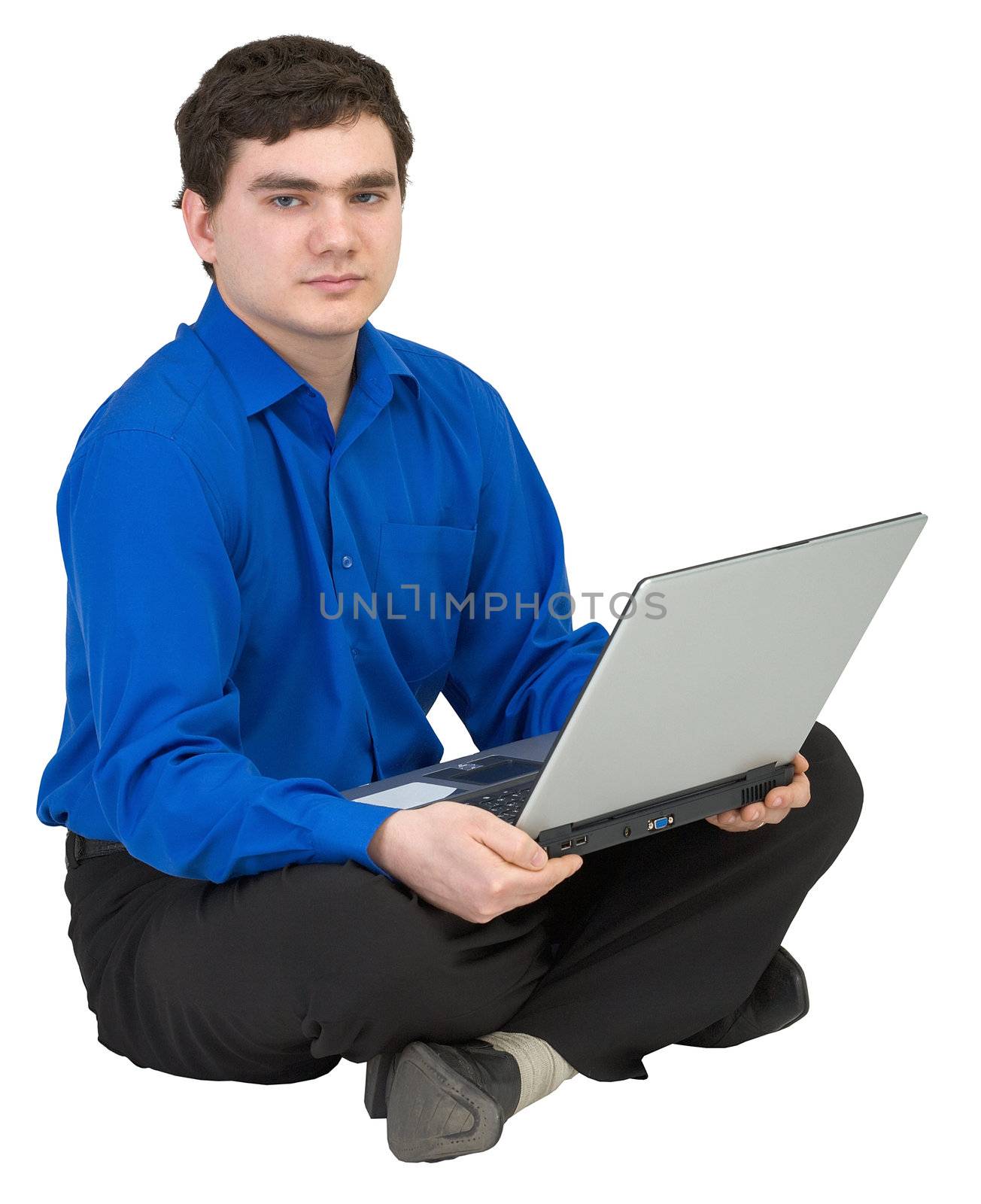 Businessman sits on a floor with the laptop in lap