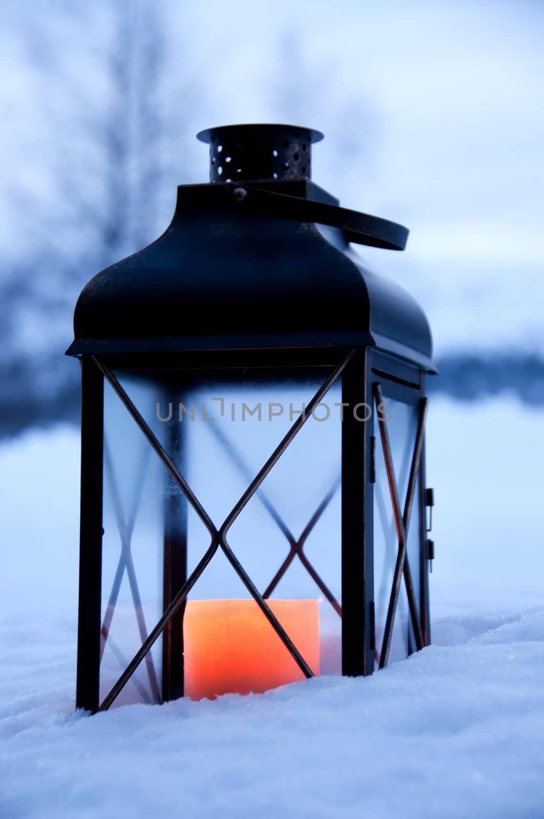 Lantern in the snow in the blue hour