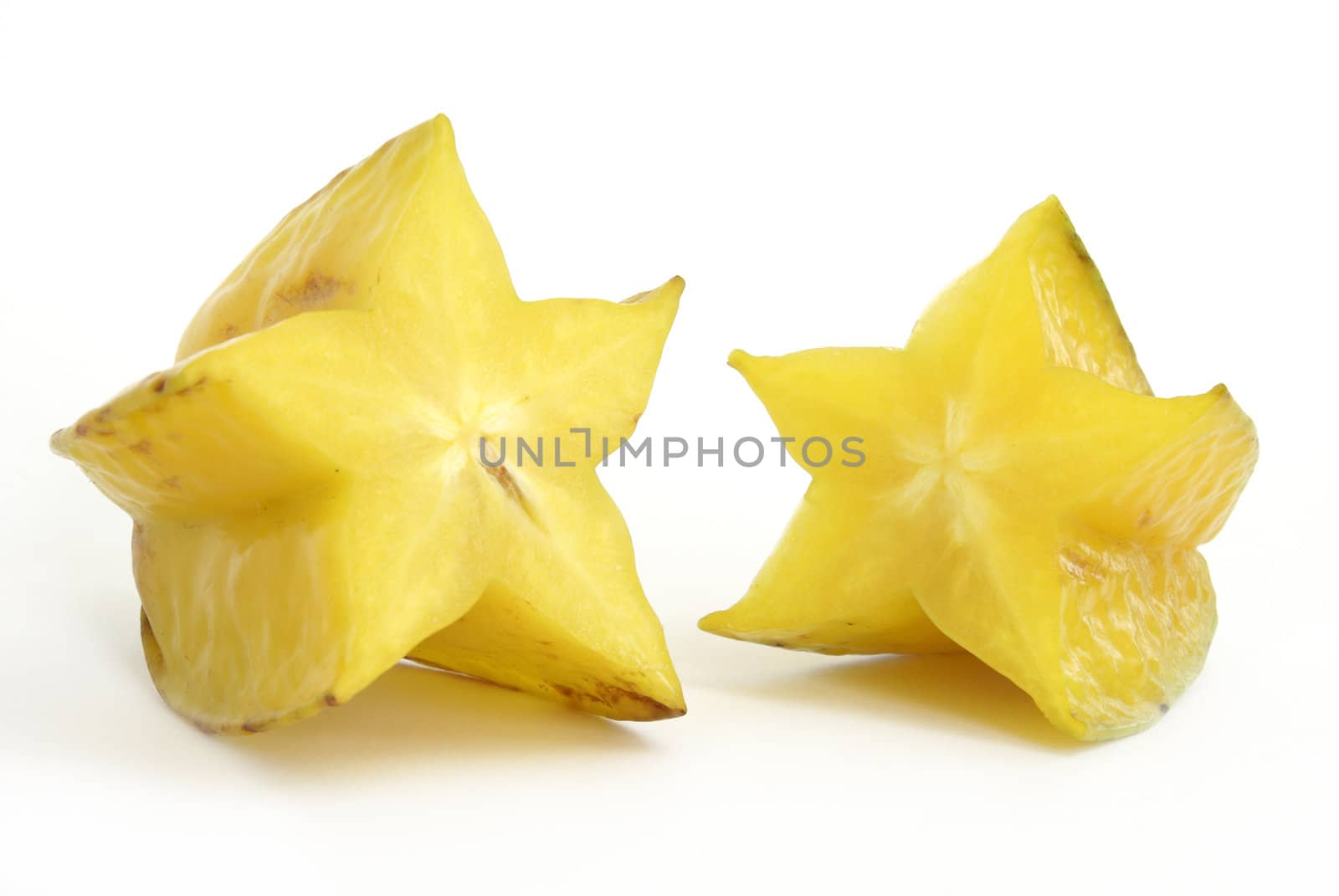 A yellow starfruit that has been cut in half.