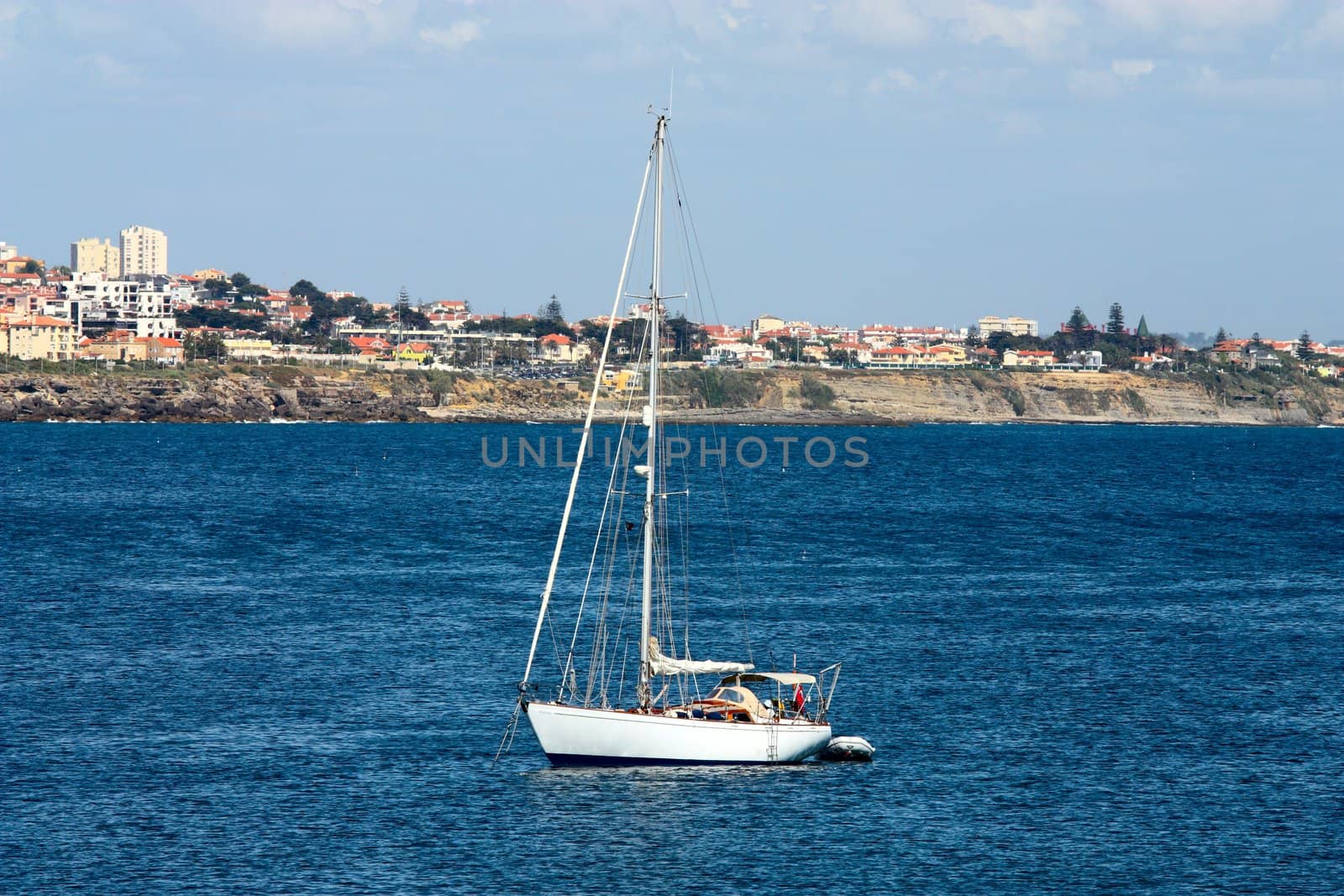 The large, beautiful yacht in the light-blue sea.