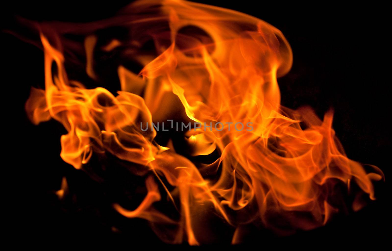 flames from a fire in the grill by bernjuer