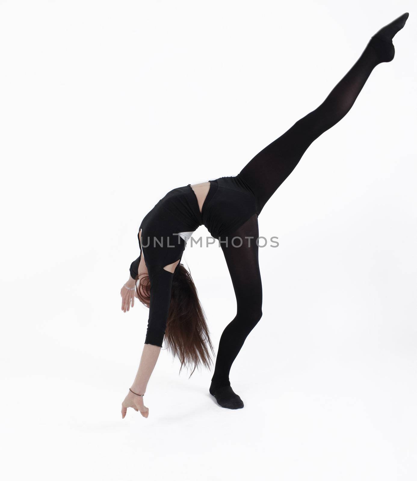 Young gymnast in black in studio with background