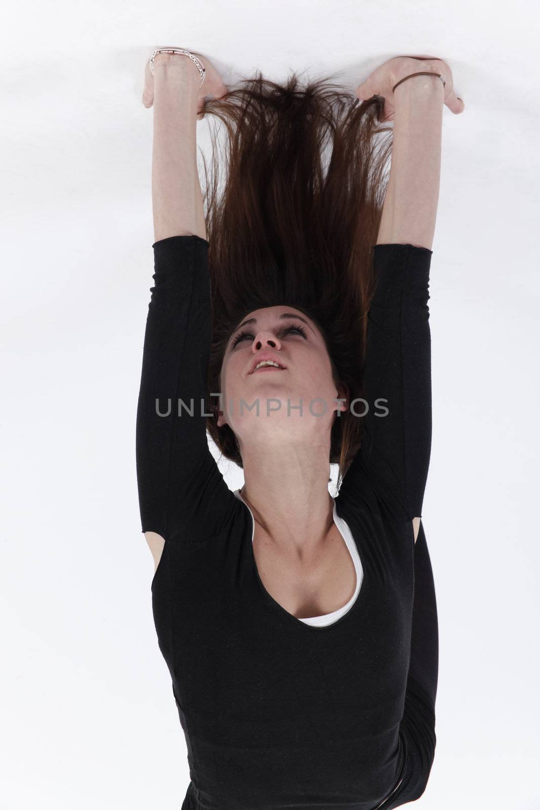 Young gymnast in black in studio with background