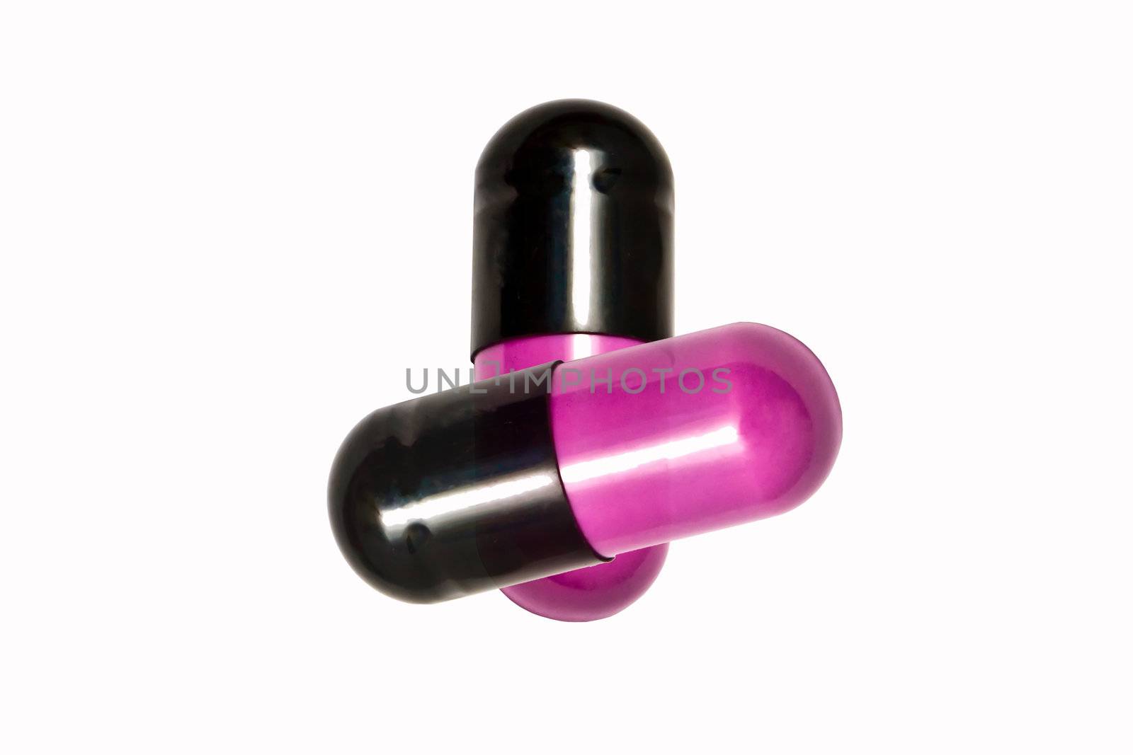 Pink capsules isolated on white background