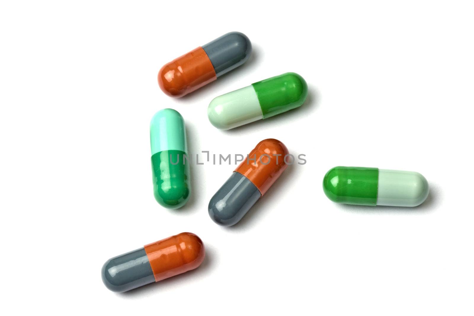 A few colorful capsules isolated on white background 
