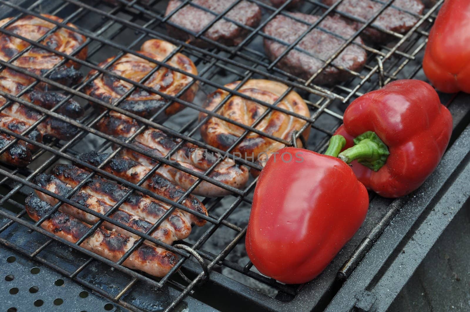 grilling fresh meat and pepers on a outdoor barbecue