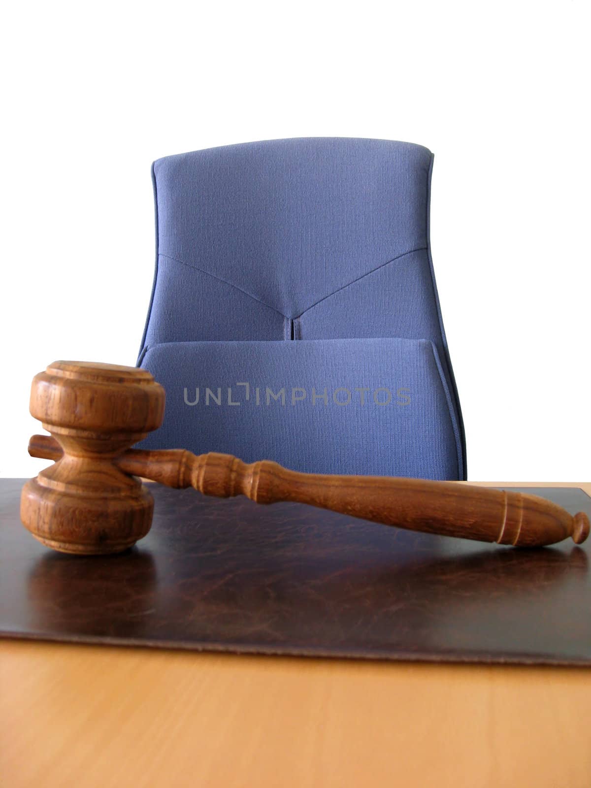Old wooden gavel ,blue chair and court desk 