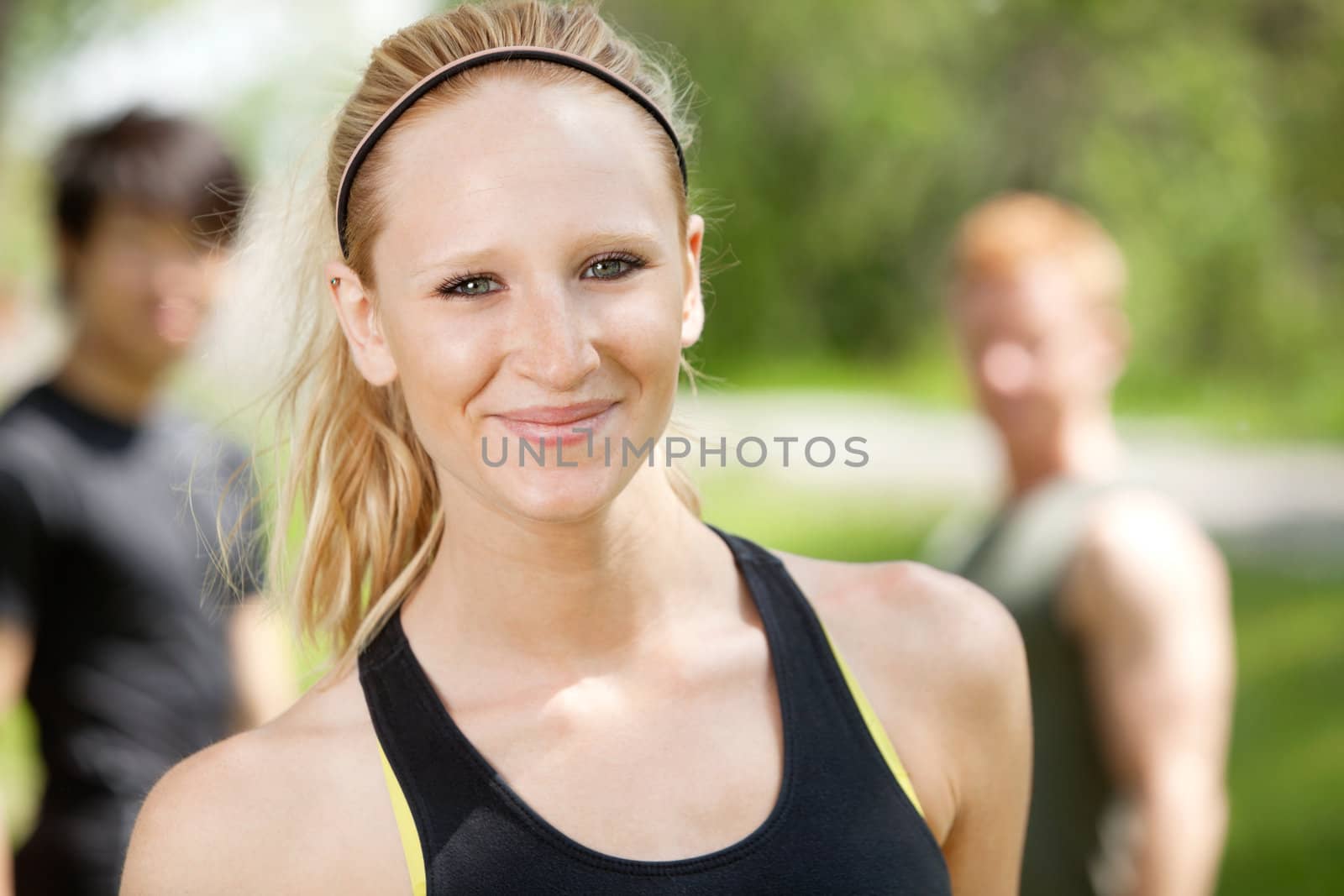 Portrait of attractive woman with friends in background